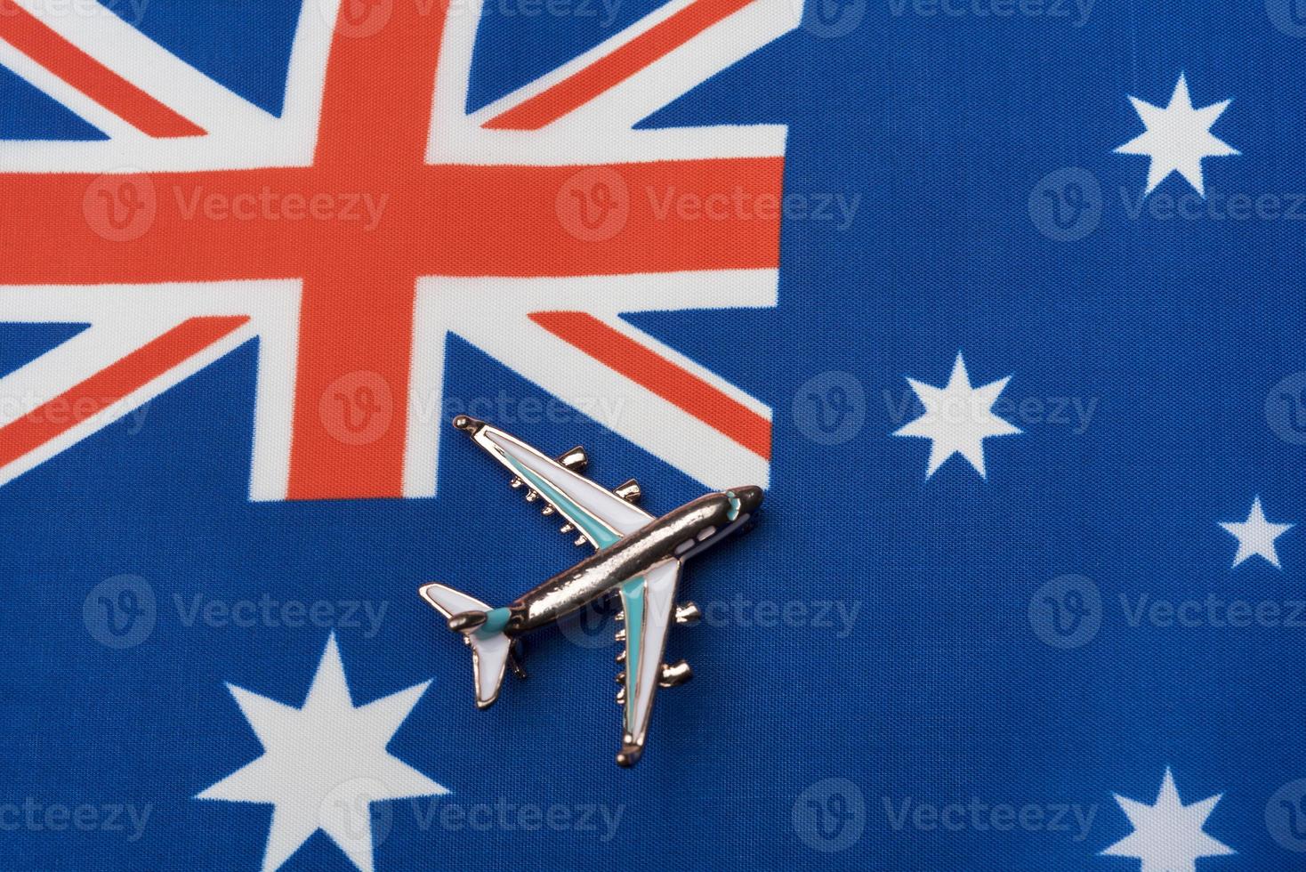 Plane over the flag of Australia, concept of travel. photo