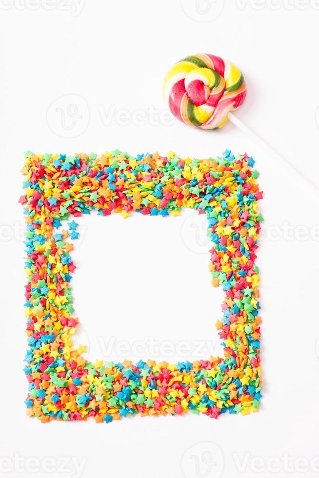 Colorful frame candy, lollipop and sweets isolated on white background. Top view. Selective focus. photo