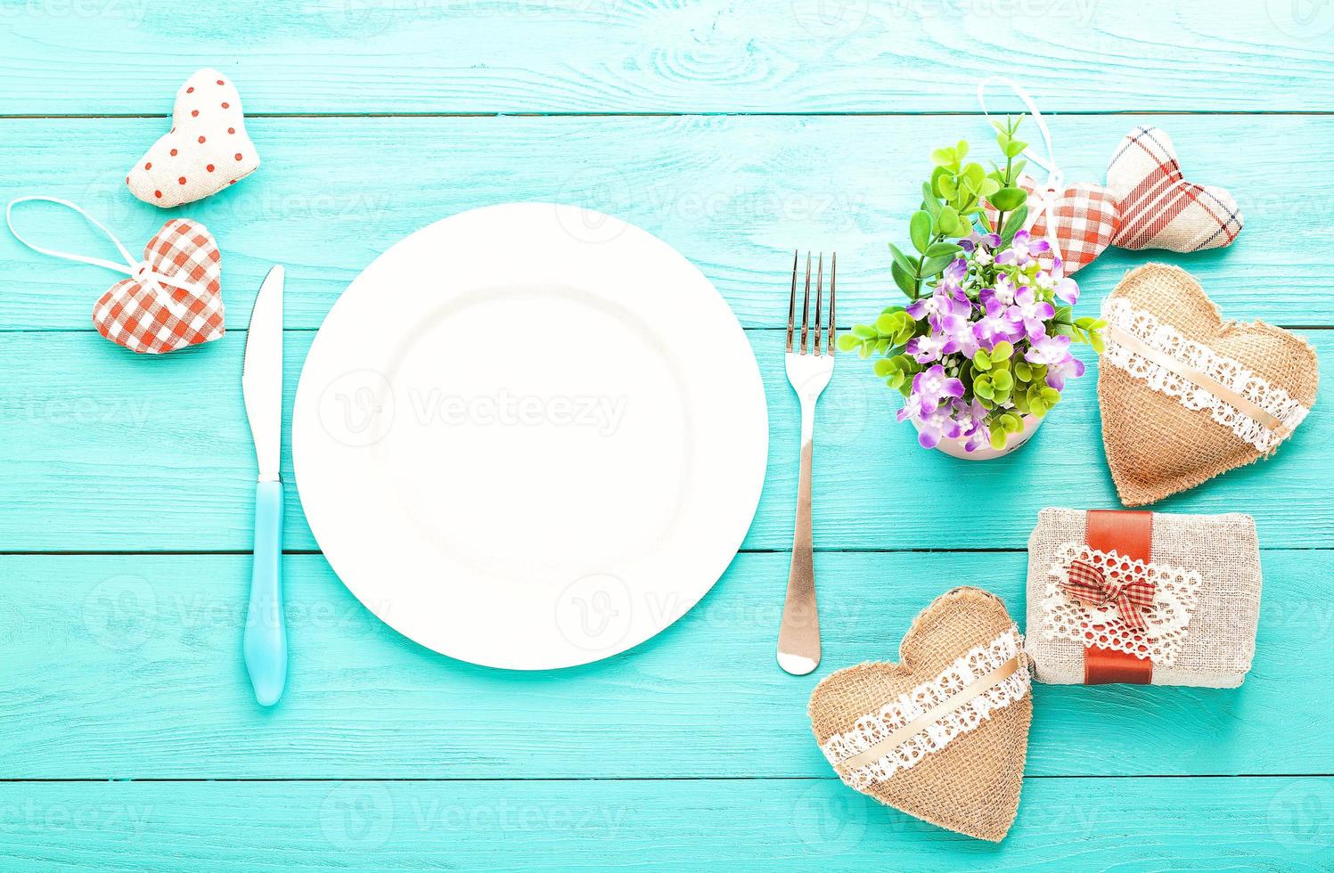 Valentines day set with silverware. Valentine day love beautiful. Romantic dinner, tableware and hearts on wooden background.Top view. photo