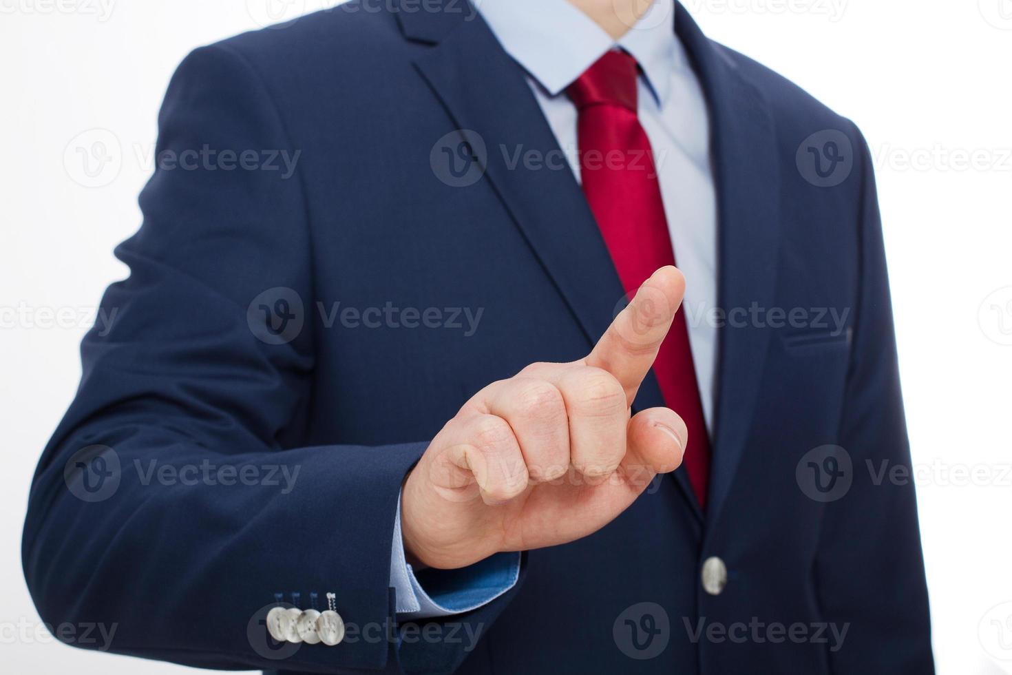 Business man finger touching empty virtual screen isolated on white background. Selective focus and copy space photo