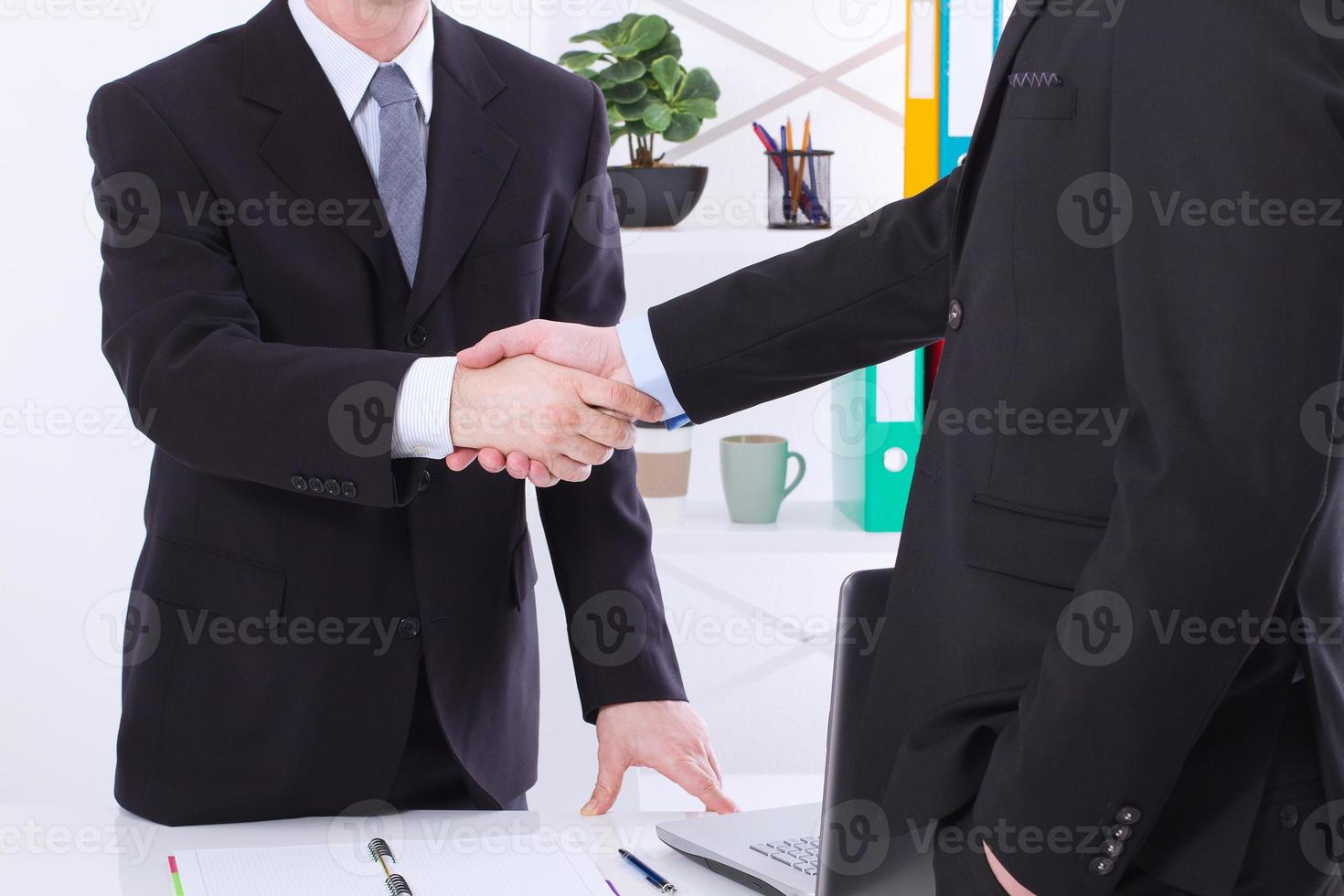 Business deal. Partnership meeting concept with successful businessmen handshaking at office background. Selective focus, copy space and horizontal photo