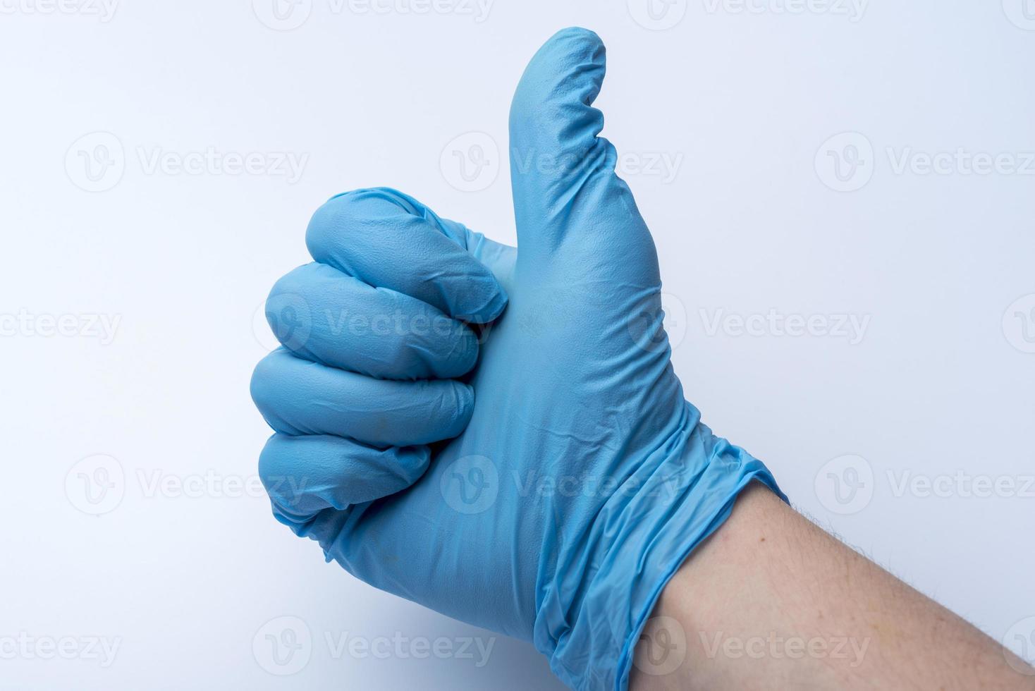 The gloved hand shows the thumbs up. photo