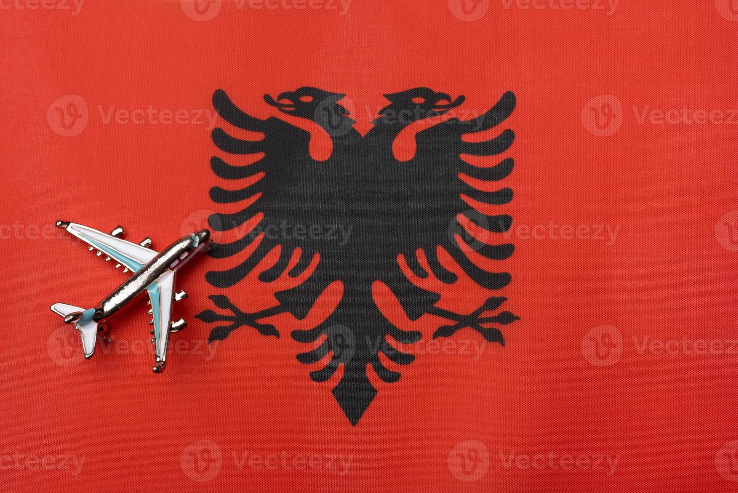 The plane over the flag of Albania, the concept of travel. photo