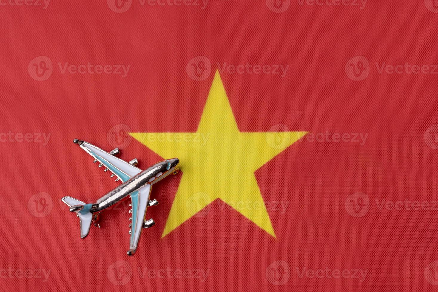 Plane over the flag of Vietnam travel concept. photo