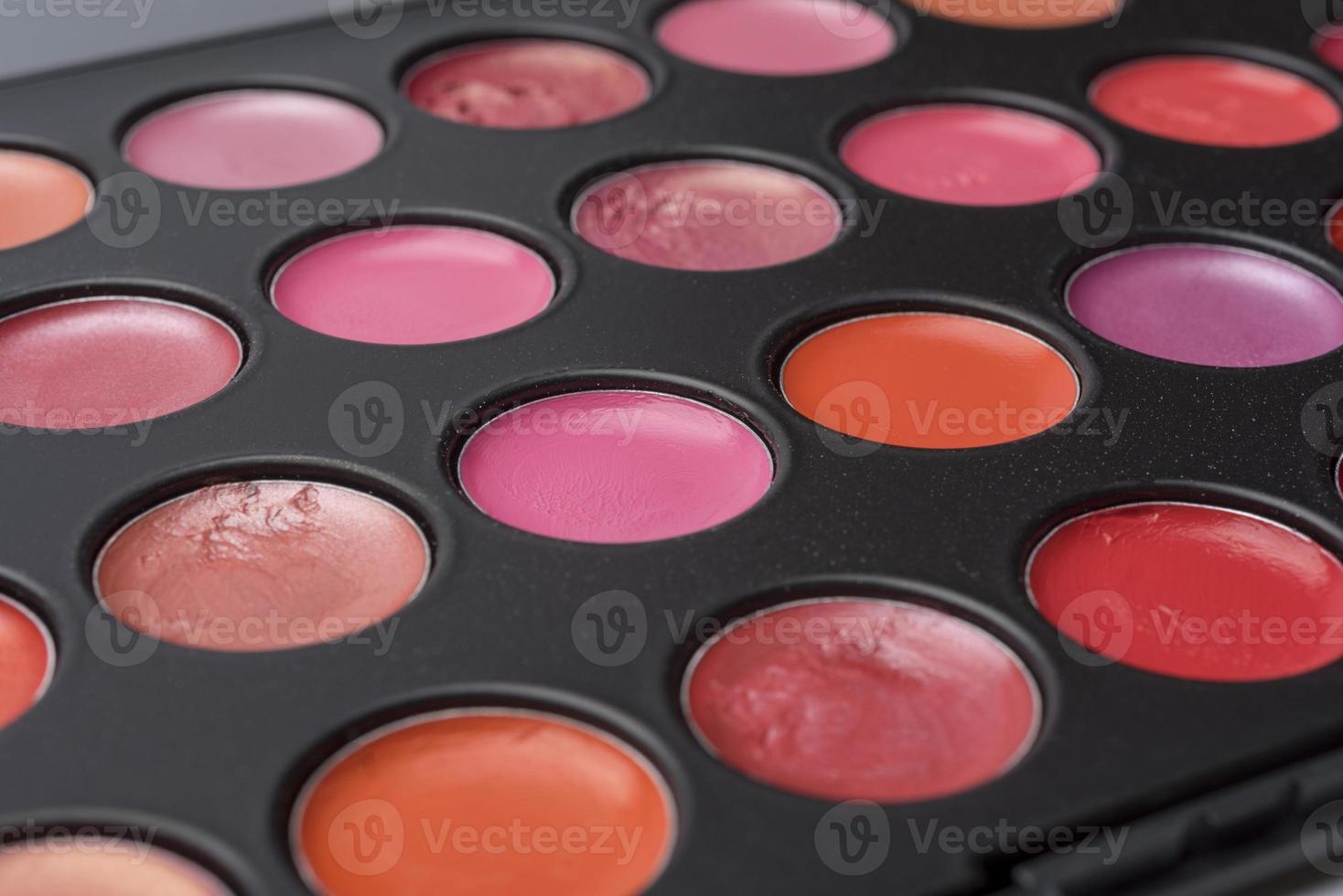 A color palette of lipstick, close-up prevailing in red tones. photo