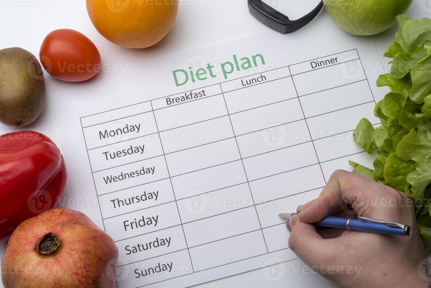 el médico escribe una receta al paciente, hace un plan de dieta en el lugar de trabajo con fruta fresca. foto