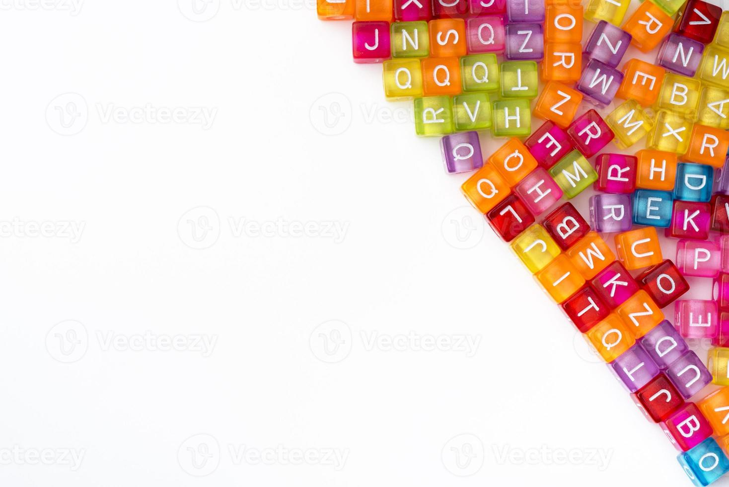 Many colorful decorative cubes with letters on a white background. photo