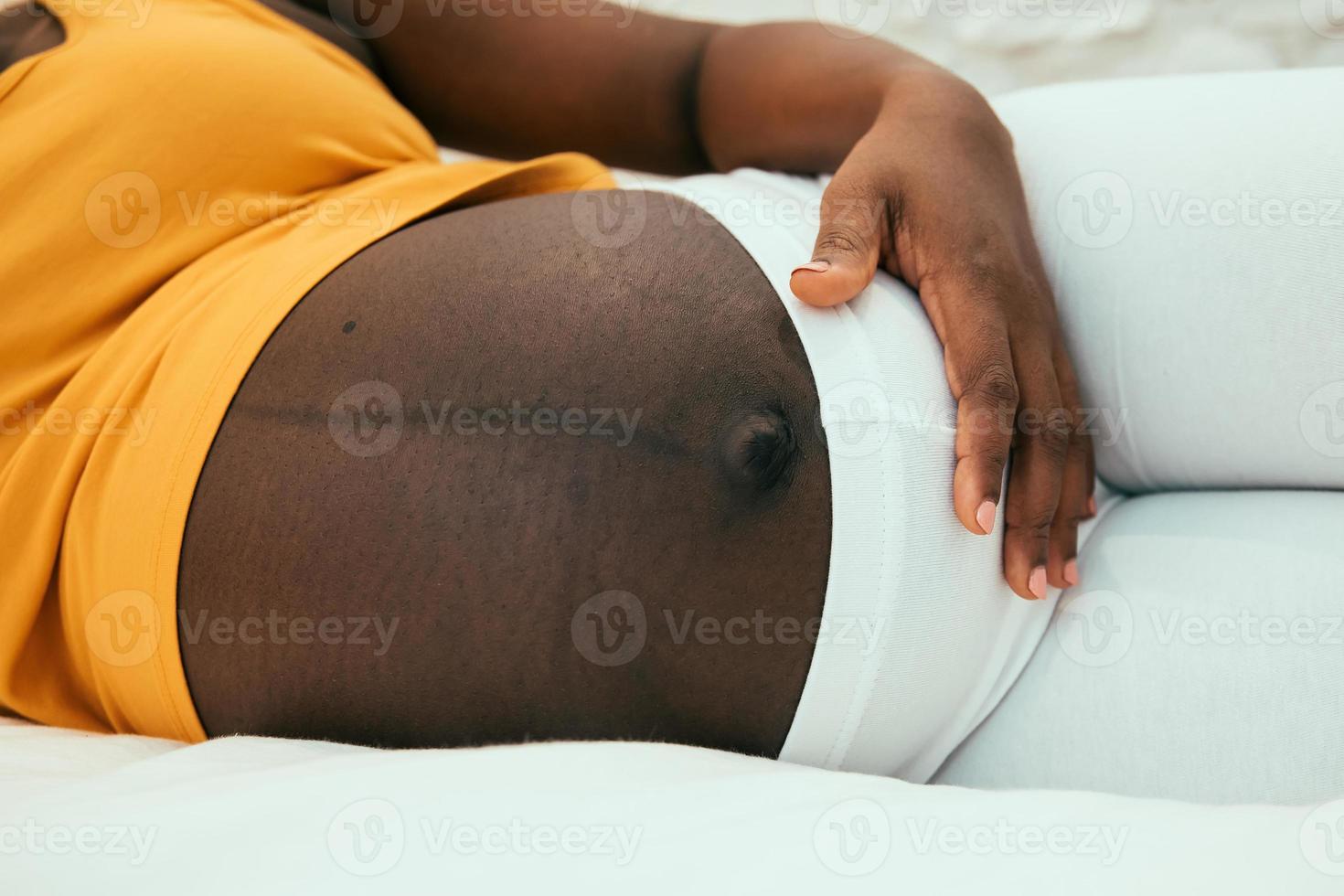 pregnant belly of a black woman photo
