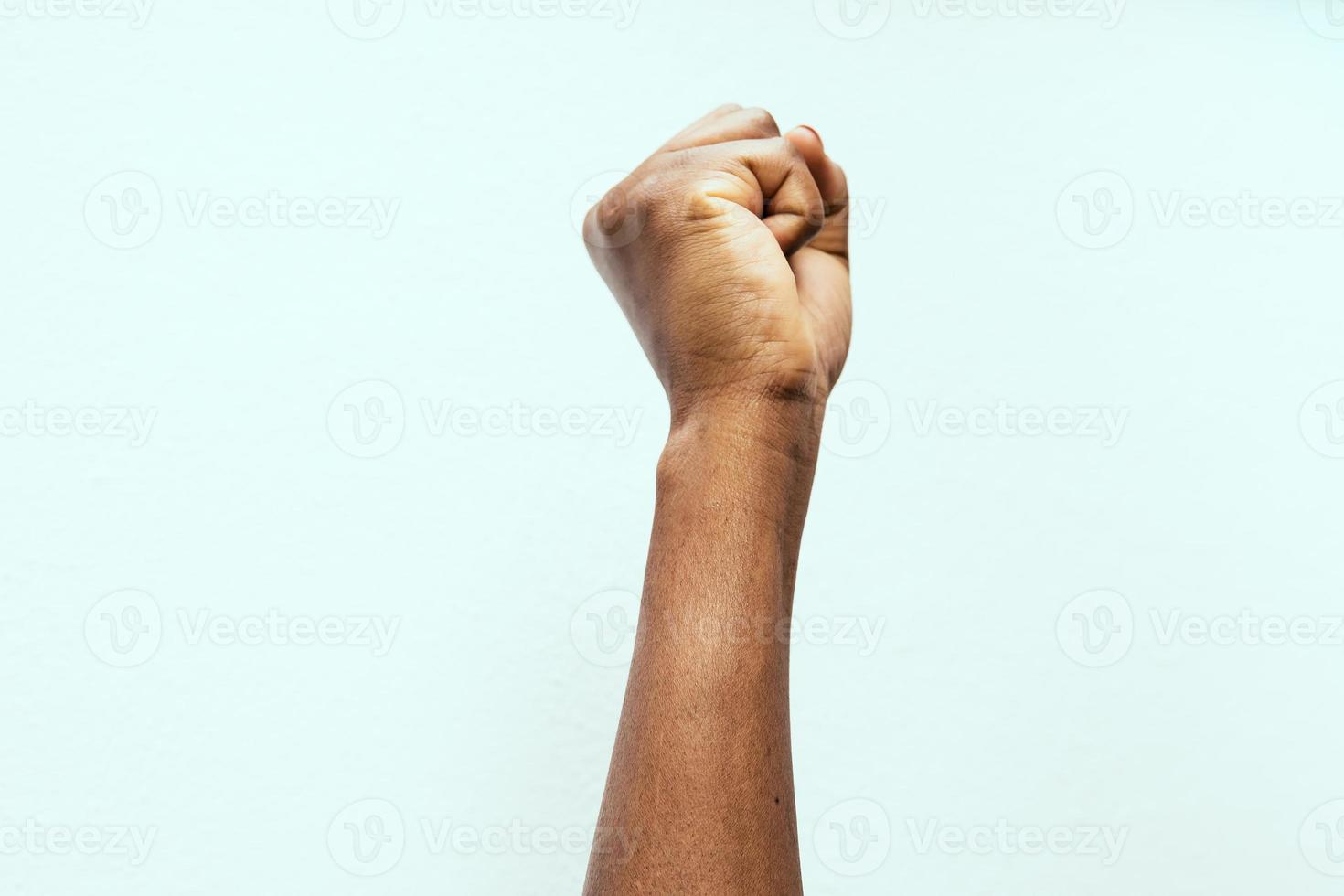 black fist in the air as a sign of power photo