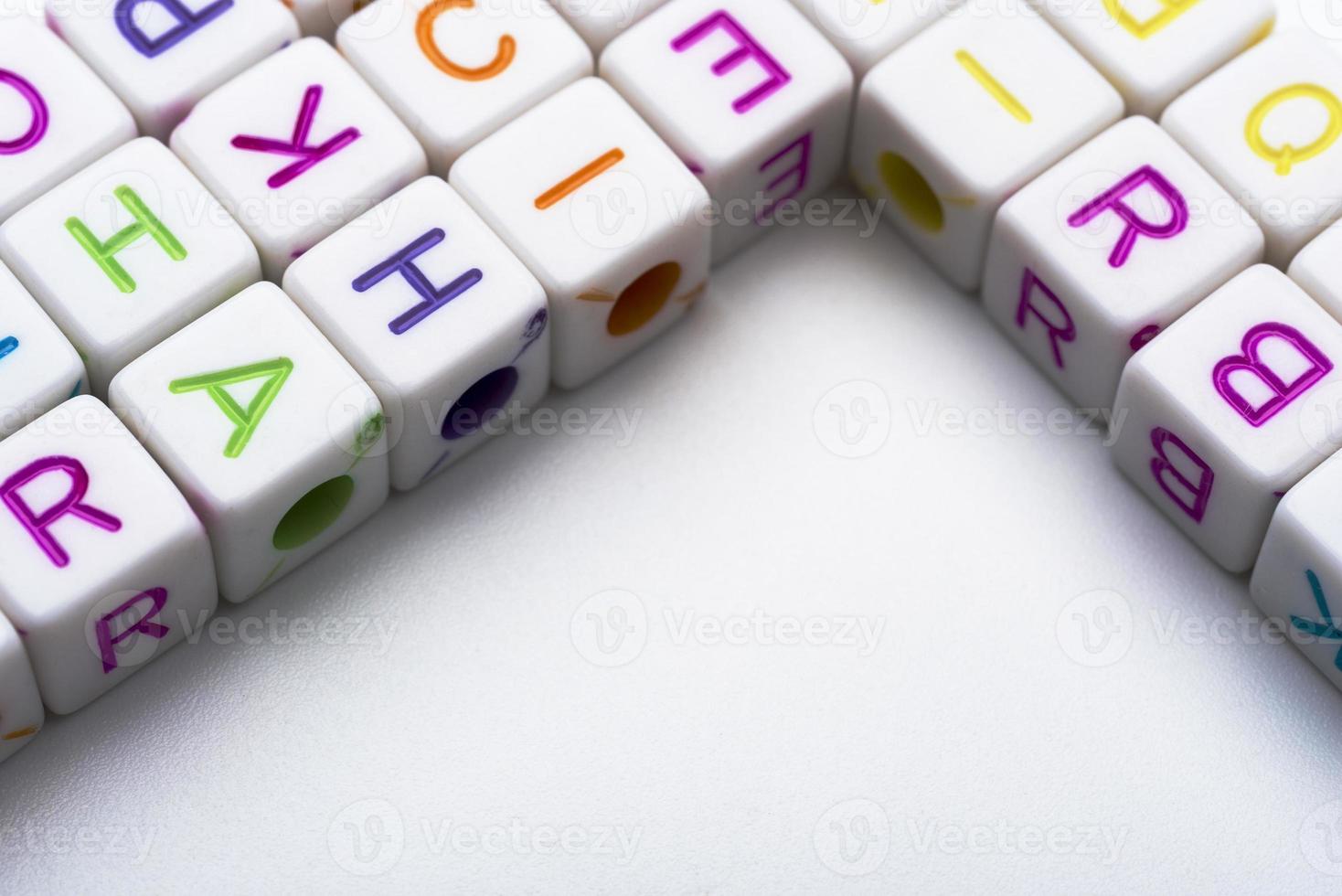 Many colorful decorative cubes with letters on a white background. photo
