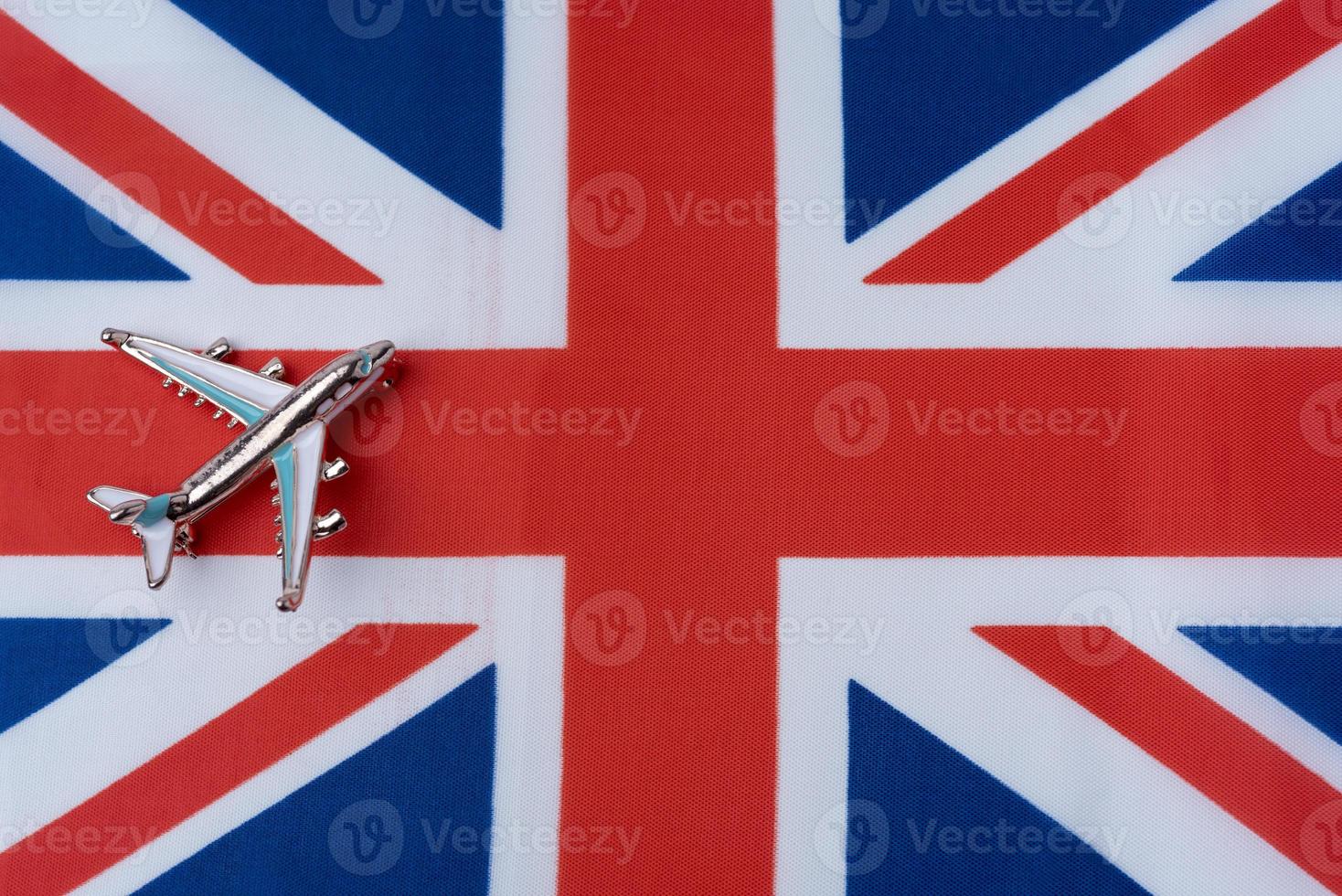 The plane over the flag of great Britain, the concept of travel. photo