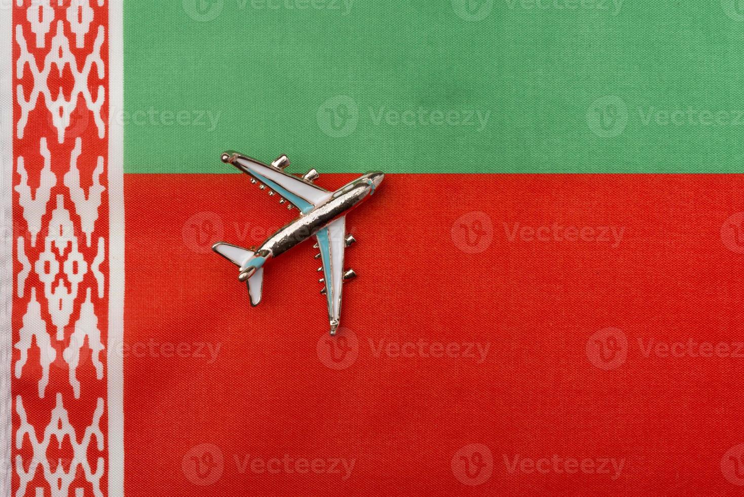 Plane over the flag of Belarus travel concept. photo