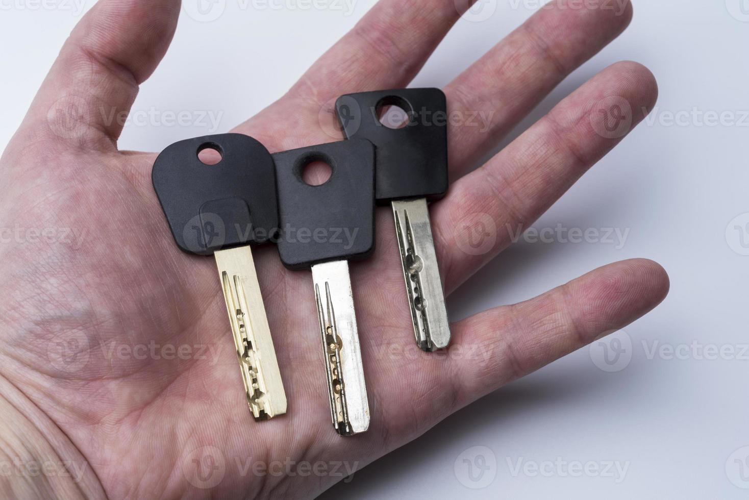 Set Of Keys On Human Palm Isolated On White Background photo