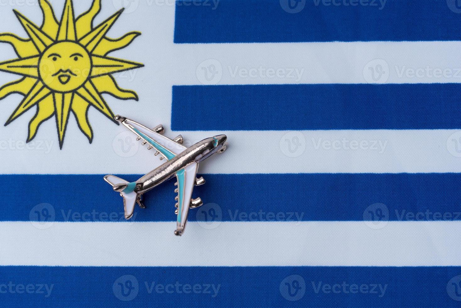 Plane over the flag of Uruguay travel concept. photo