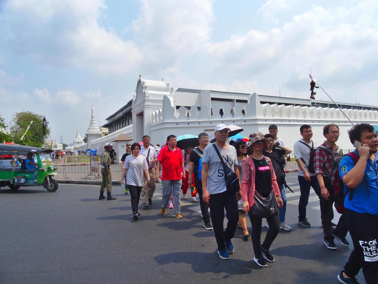 Wat Phra Kaew Temple of the Emerald BuddhaBANGKOK THAILAND15 FEBRUARY 2019Tourists walk around the area large groups showing red popular in this place..on BANGKOK THAILAND15 FEBRUARY 2019 photo