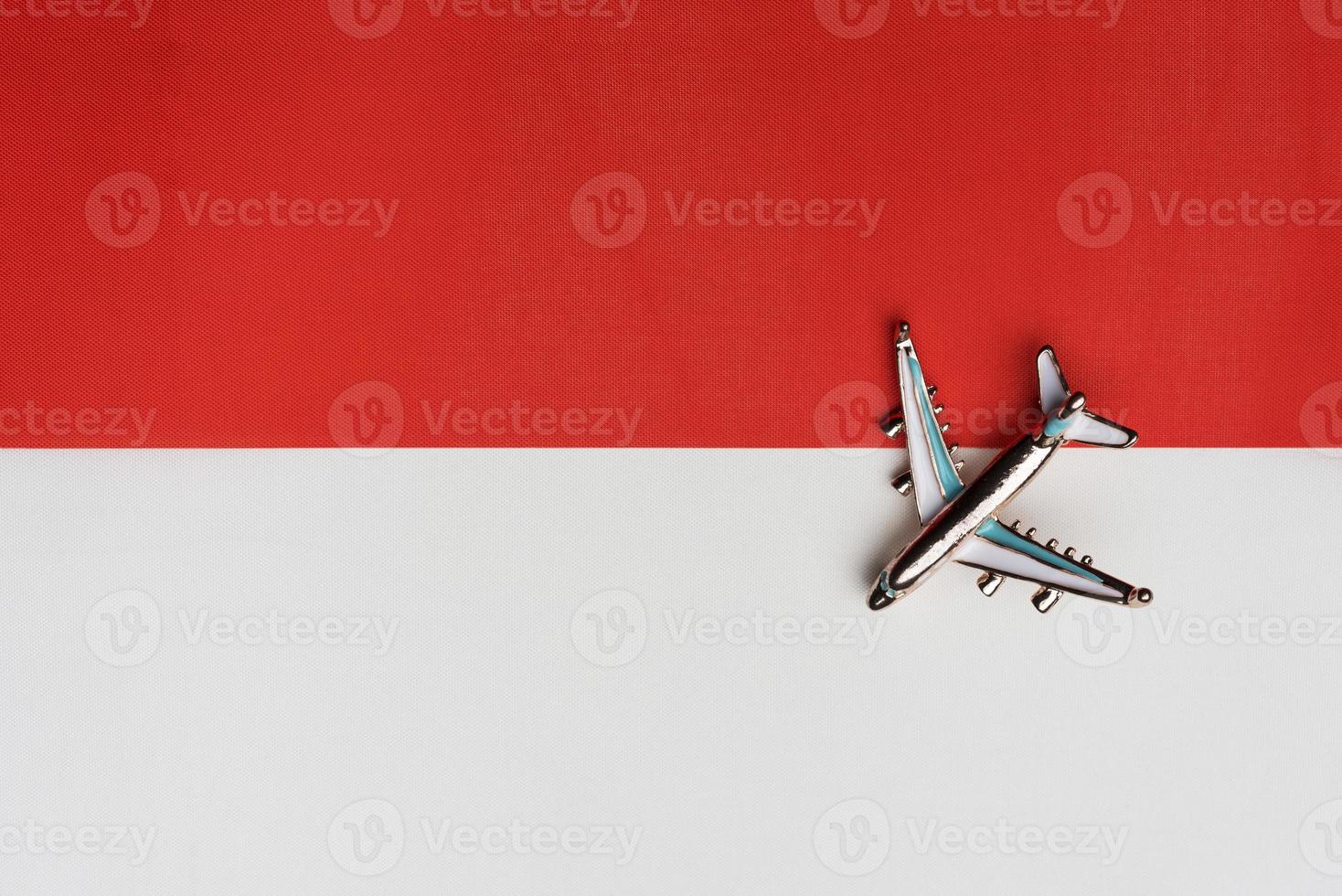 Plane over the flag of Indonesia, the concept of journey. photo