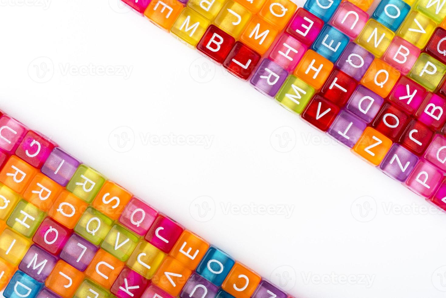 Many colorful decorative cubes with letters on a white background. photo