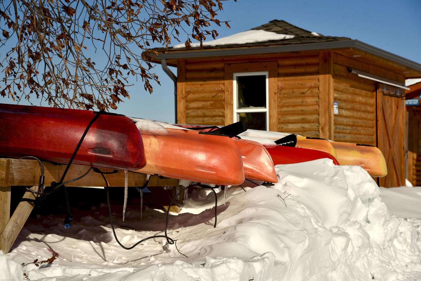 winter in Manitoba - colorful canoes stored in the snow photo