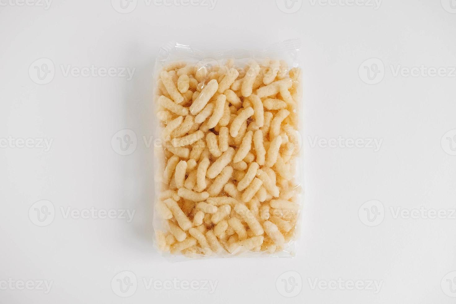 Corn sticks in a plastic bag on a white background. Top view. Copy, empty space for text photo