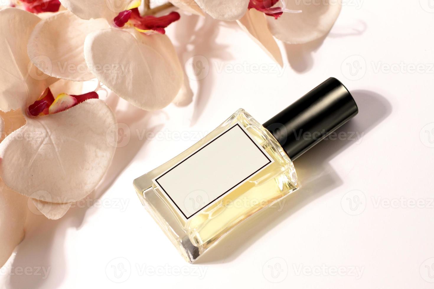 Glass perfume bottle with orchid, moke up photo