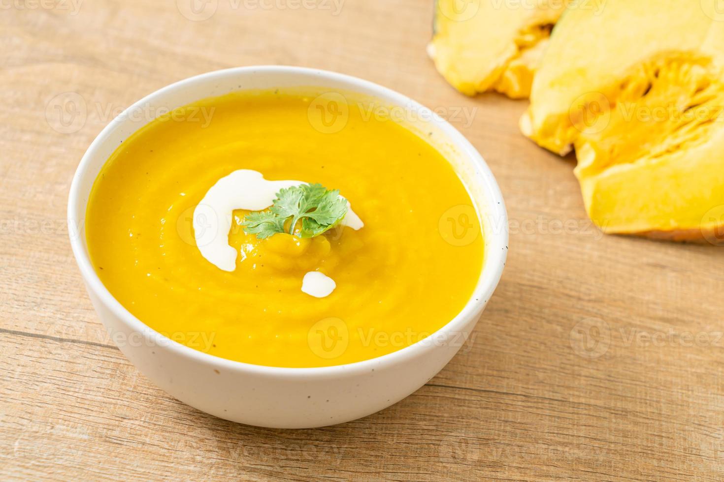 pumpkin soup in white bowl photo