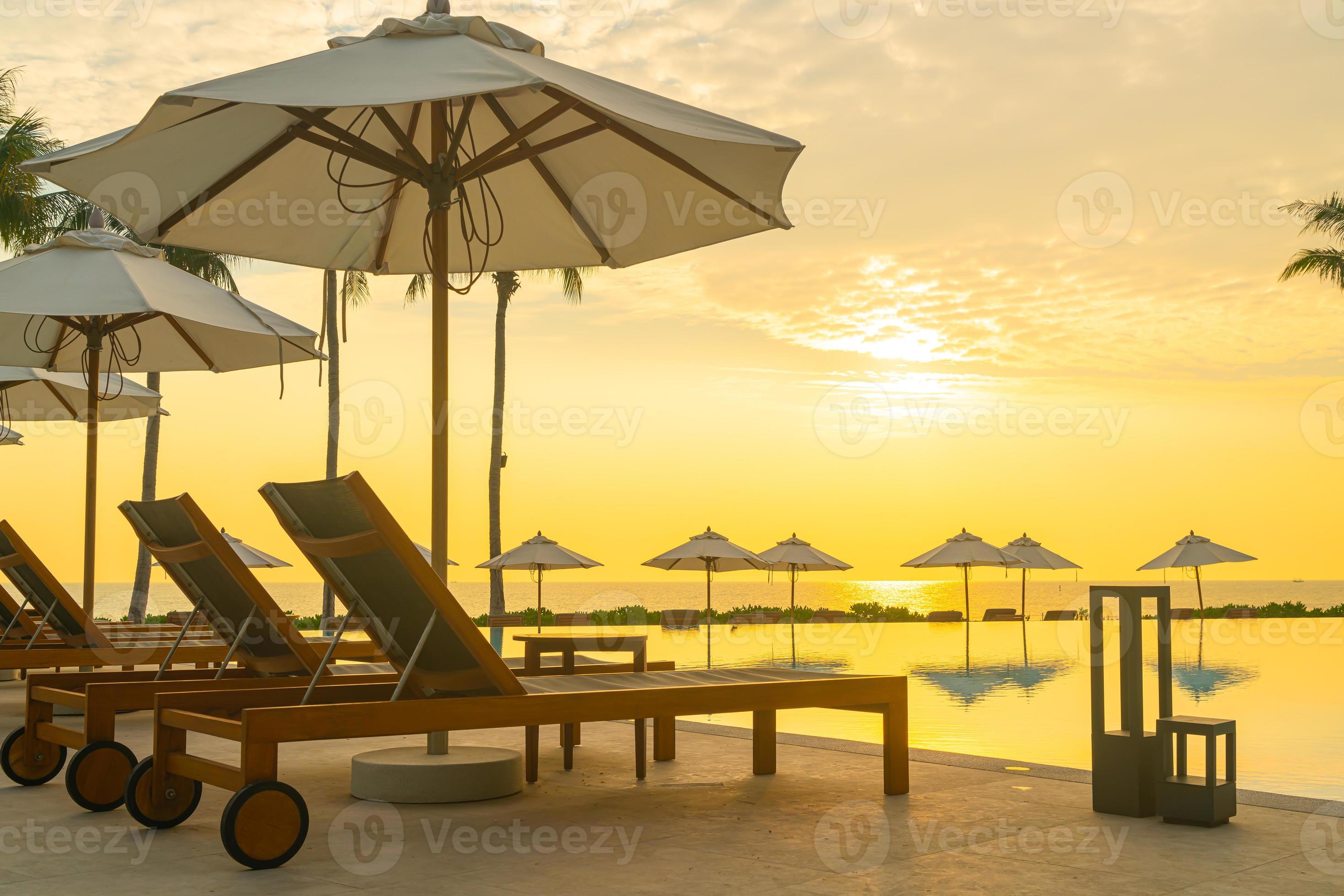 umbrella with bed pool around swimming pool with ocean sea background