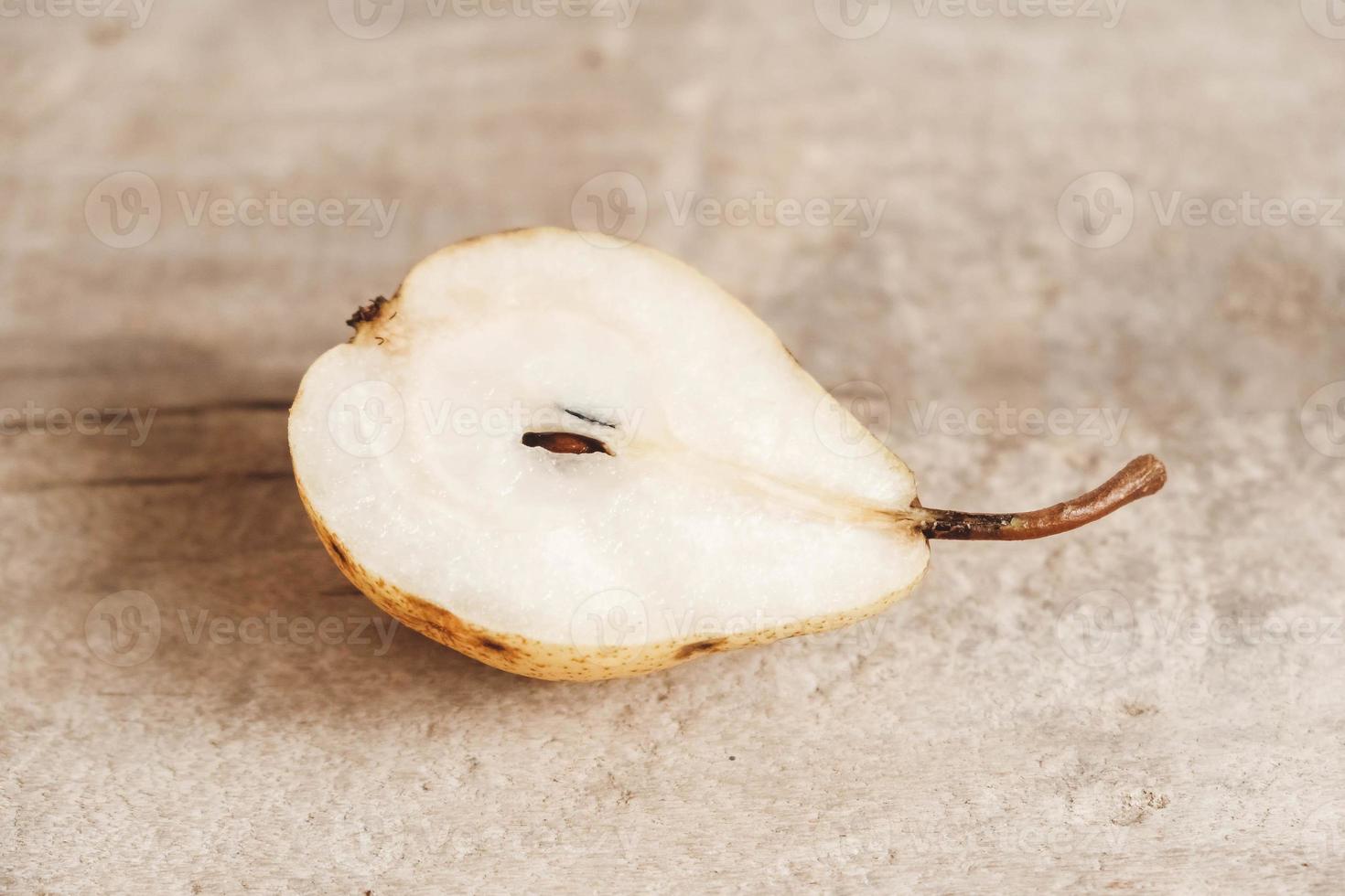 Sliced pear on a old wood background photo