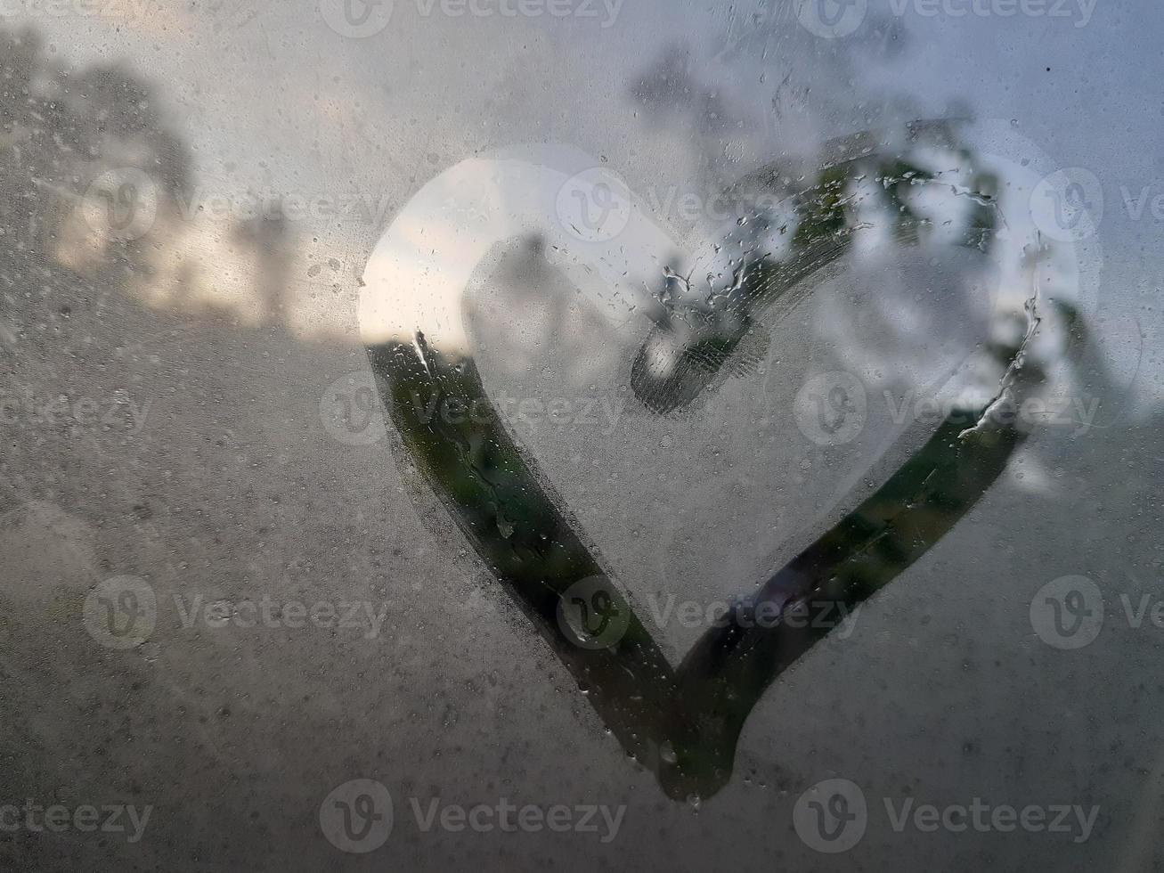 Love sign on fogging glass photo