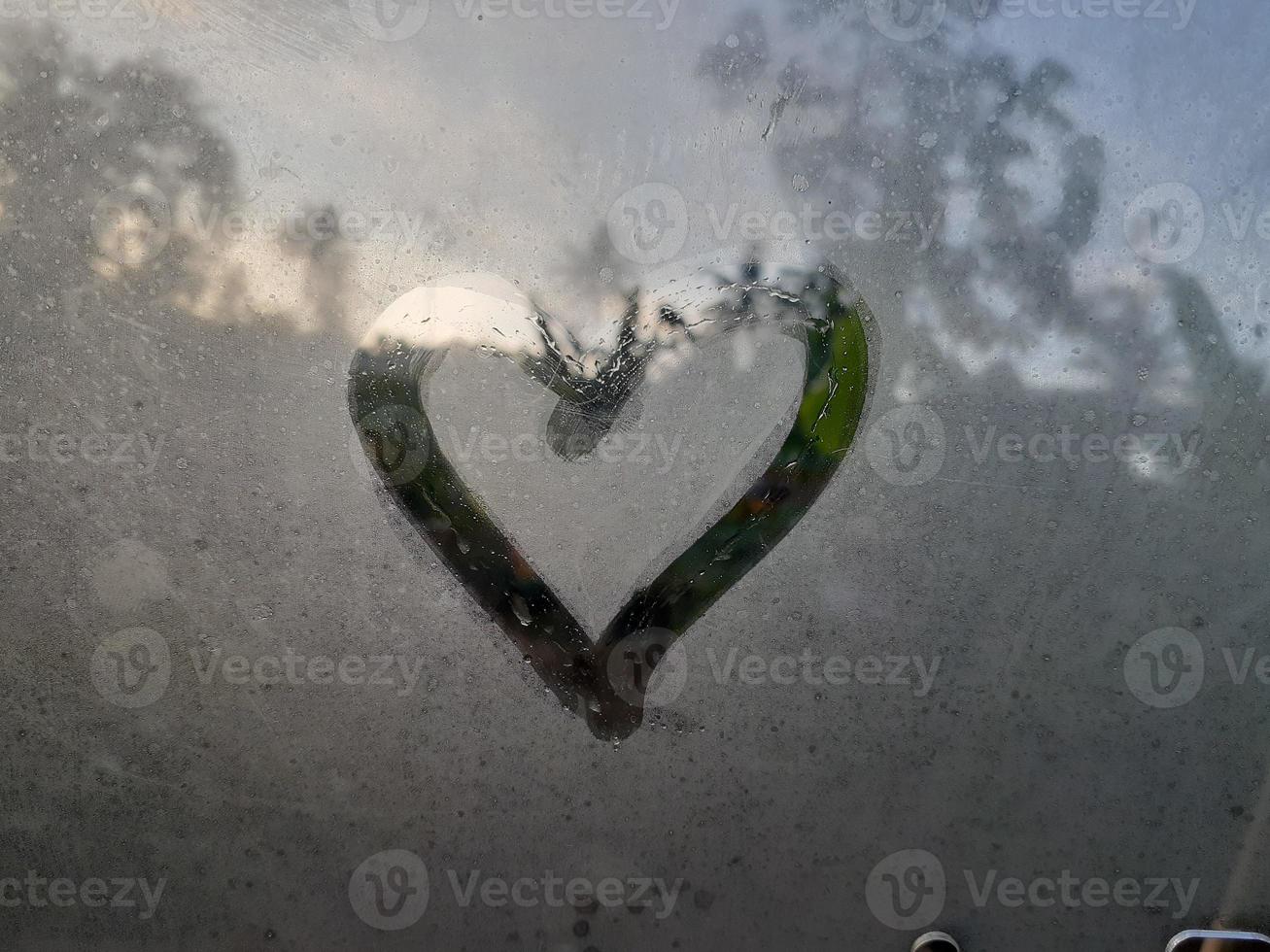 Love sign on fogging glass photo