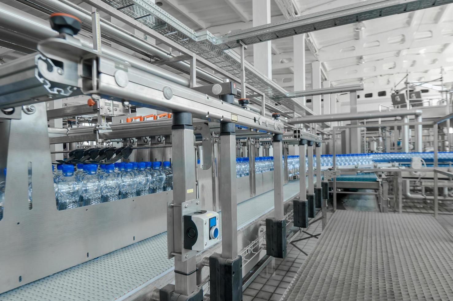 Tashkent, Uzbekistan - June 7, 2016 - Plant for the production of plastic bottles.  Plastic bottles on a conveyor belt. Bottled water filling photo