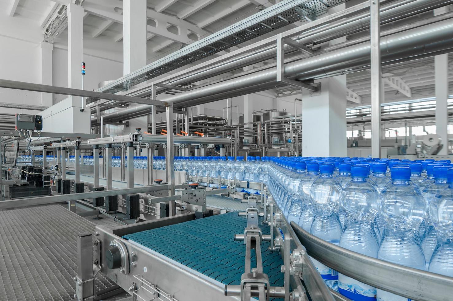 Tashkent, Uzbekistan - June 7, 2016 - Plant for the production of plastic bottles.  Plastic bottles on a conveyor belt. Bottled water filling photo