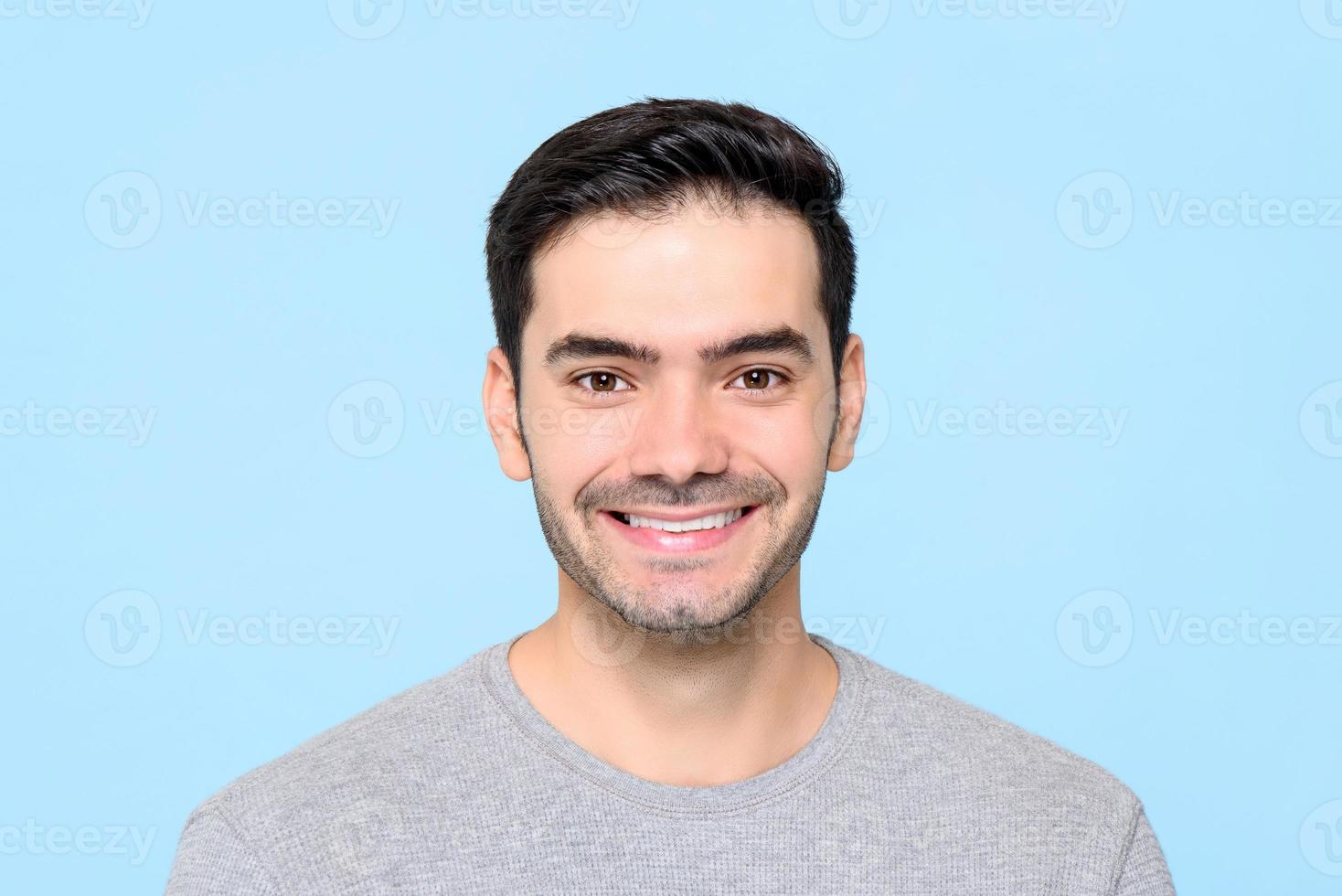 Friendly handsome smiling Caucasian man isolated light blue background photo