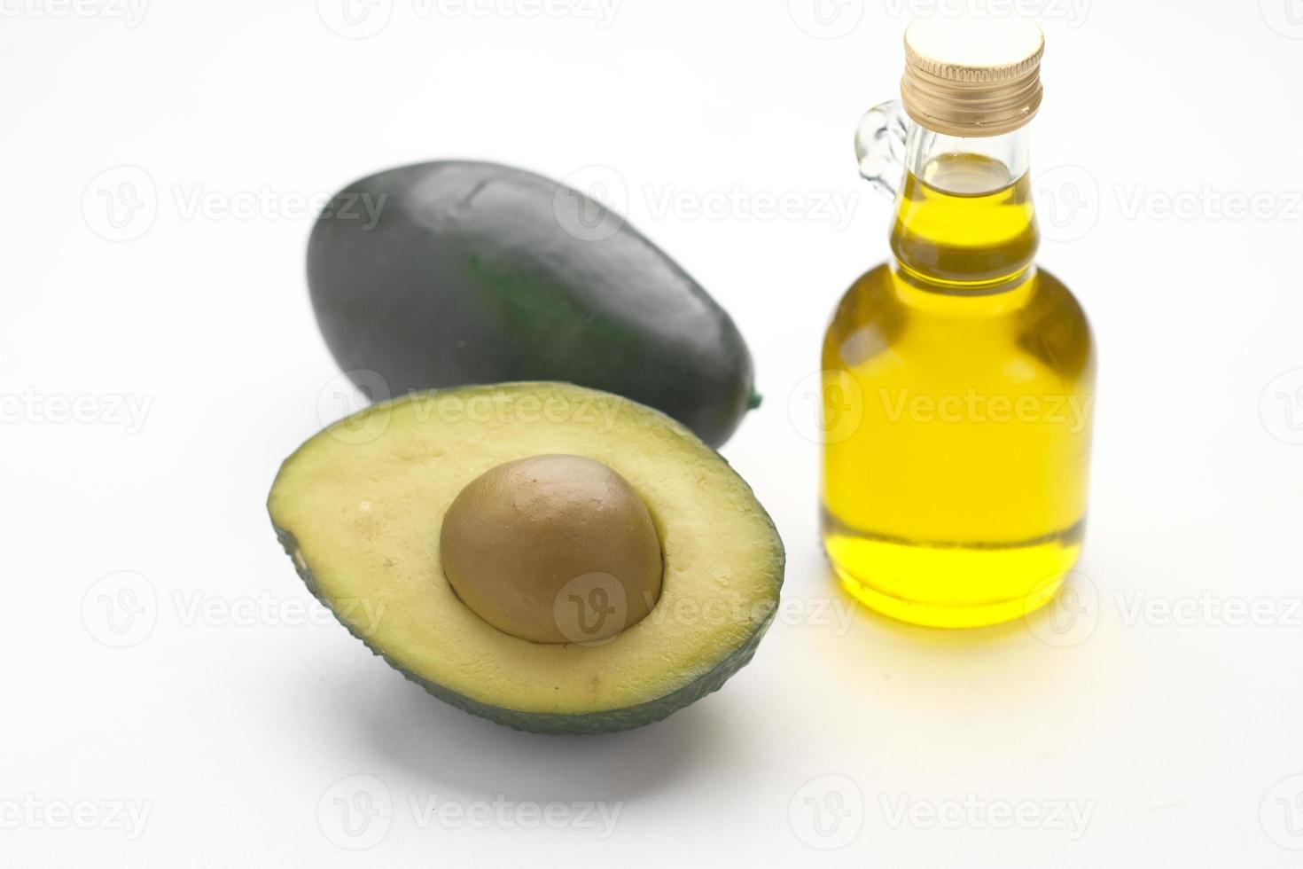 oil and slice of avocado on wooden table photo