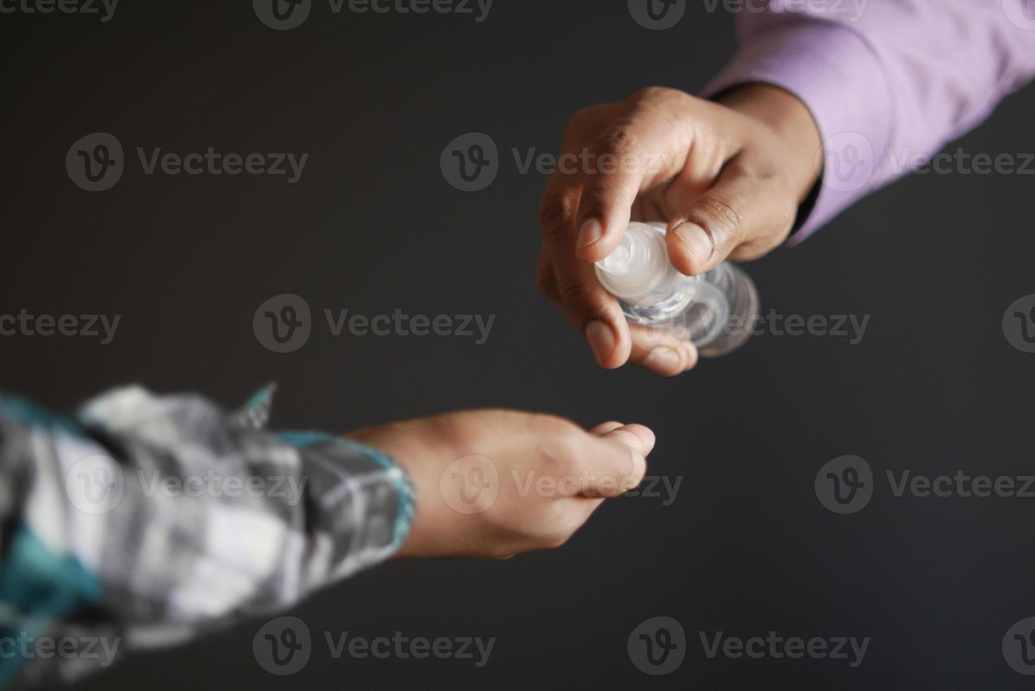 two people using sanitizer gel for preventing virus. photo