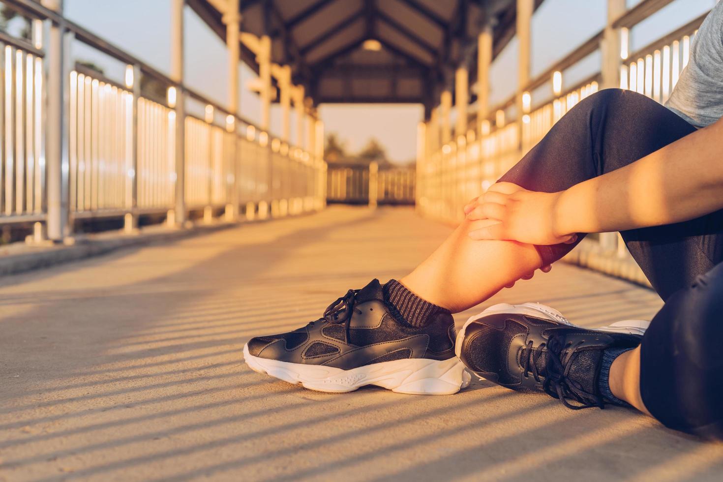 woman doing leg massage on footbridge photo