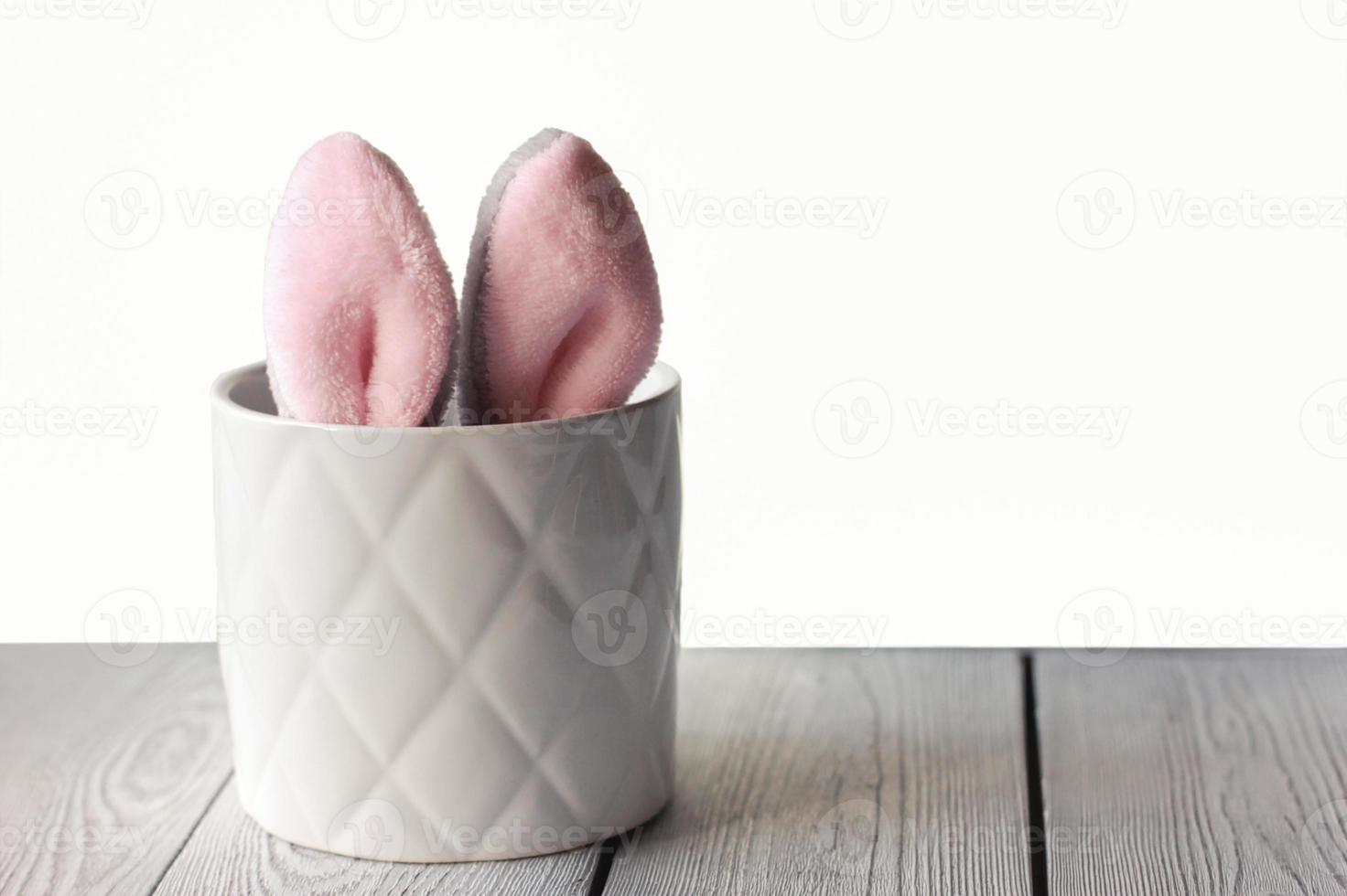 Easter bunny ears showing in flower pot photo