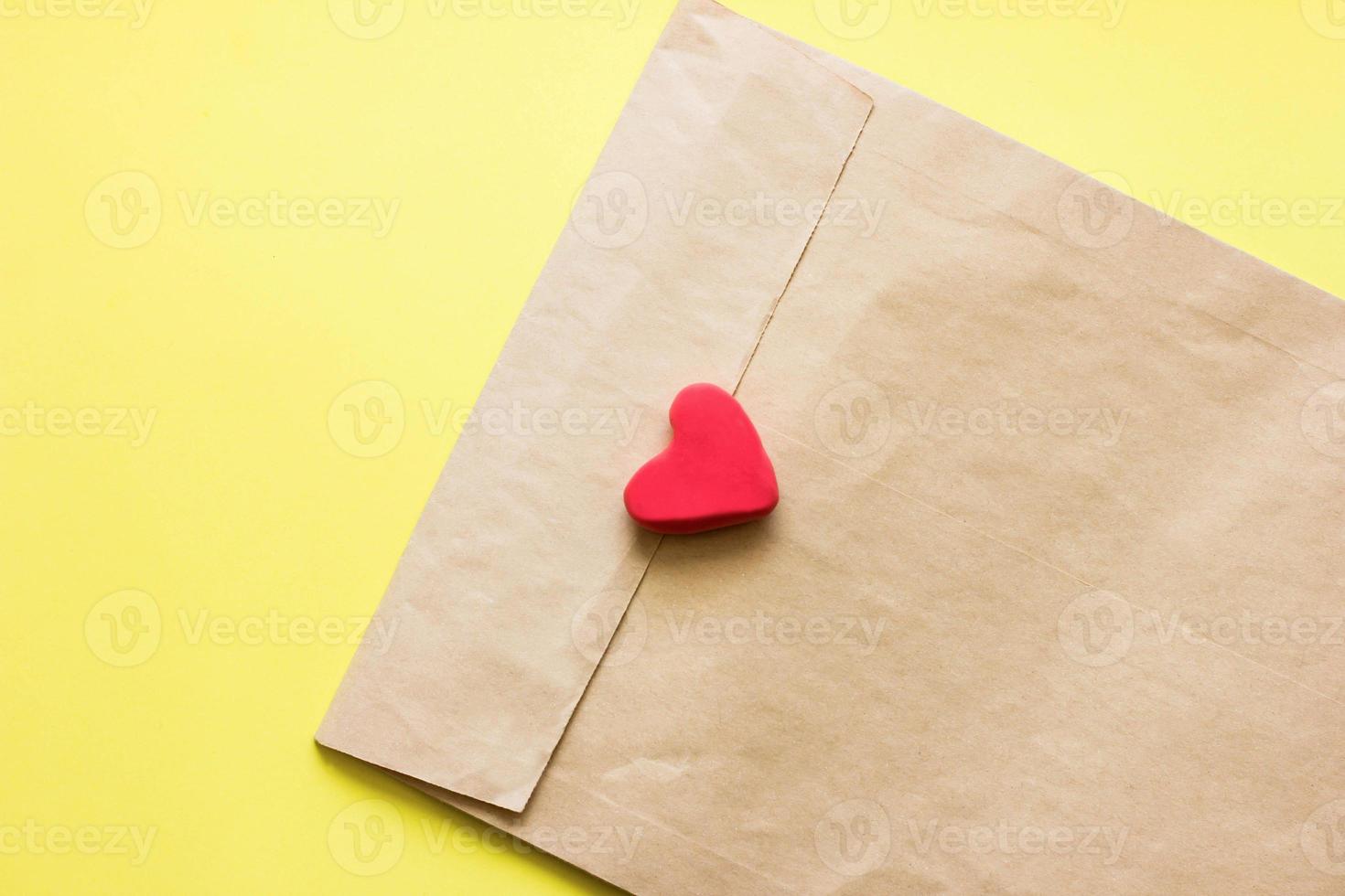 love letter in a craft envelope with a sealing heart. copy space for text. photo