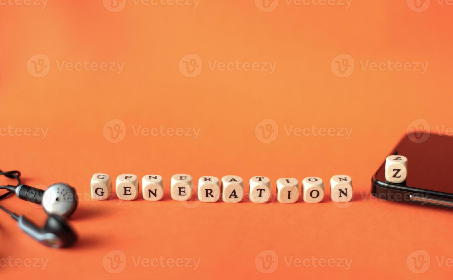 black smartphone and earphones. Dice with letters Generation Z. photo