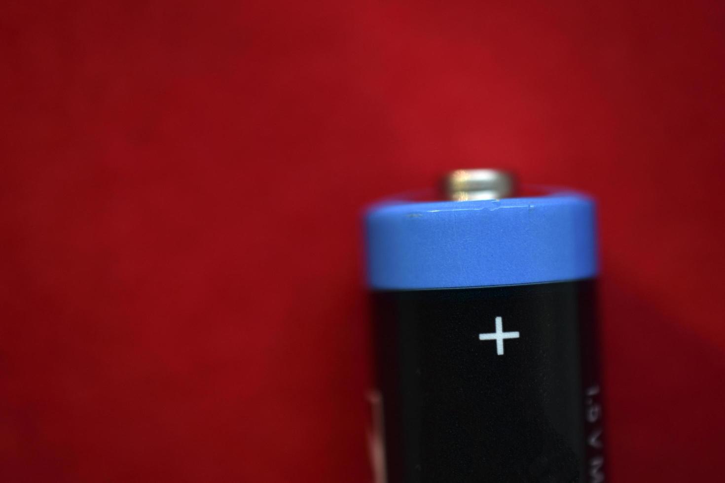 AA finger battery on a red background photo