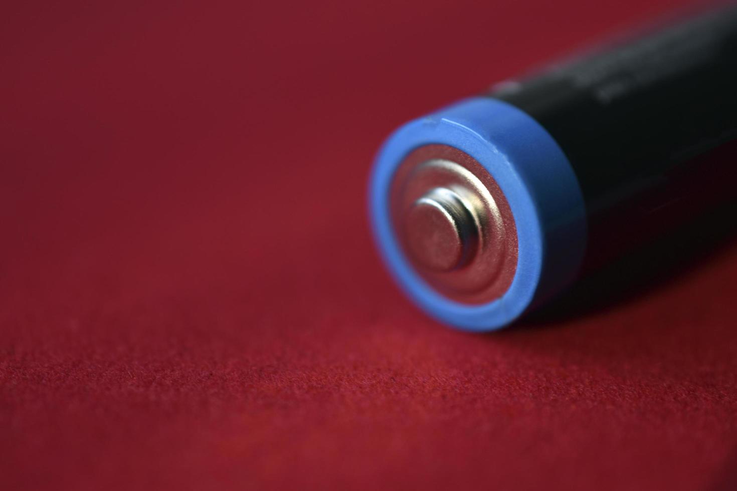 AA finger battery on a red background photo