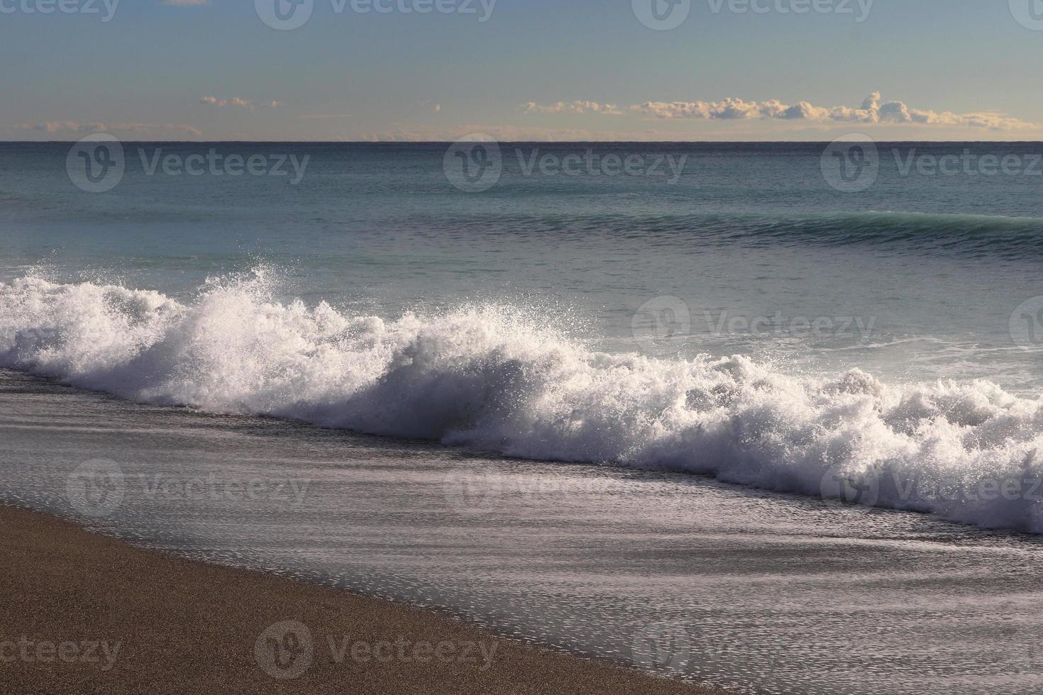Calm sea beach with splashing wave seascape. photo
