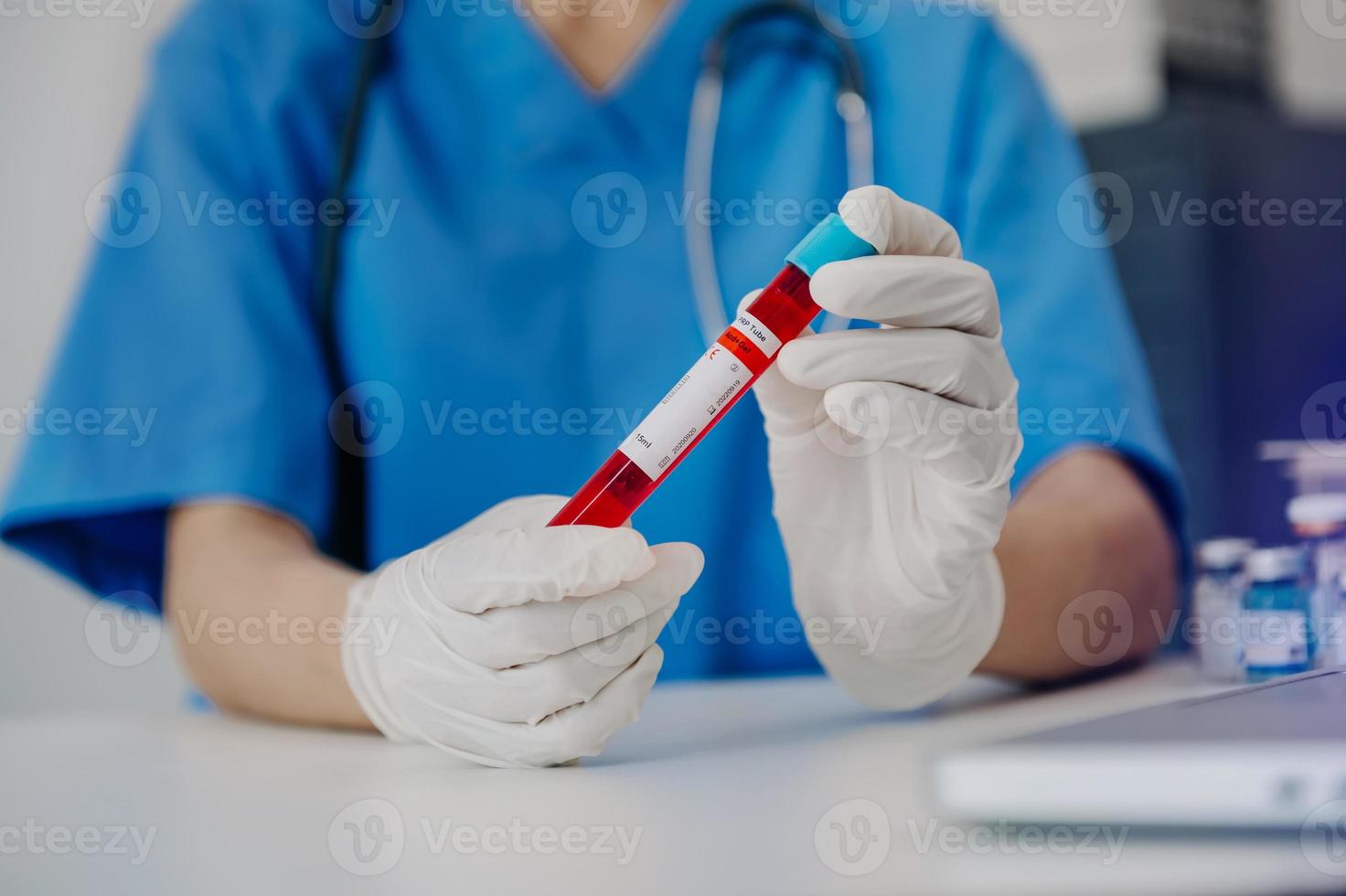 Scientist holding test tube with blood sample, focus on hand photo