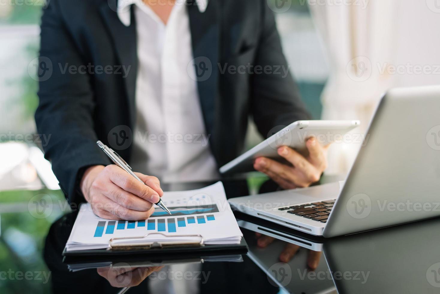 businessman hand working with new modern computer and writing on the notepad strategy diagram as concept morning light photo