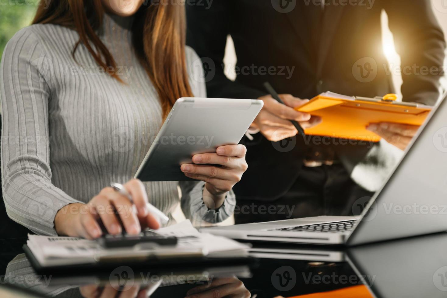 Team business meeting presentation. Hand businessman working project in modern office.Laptop computer and tablet and smart phone on white desk in morning light photo