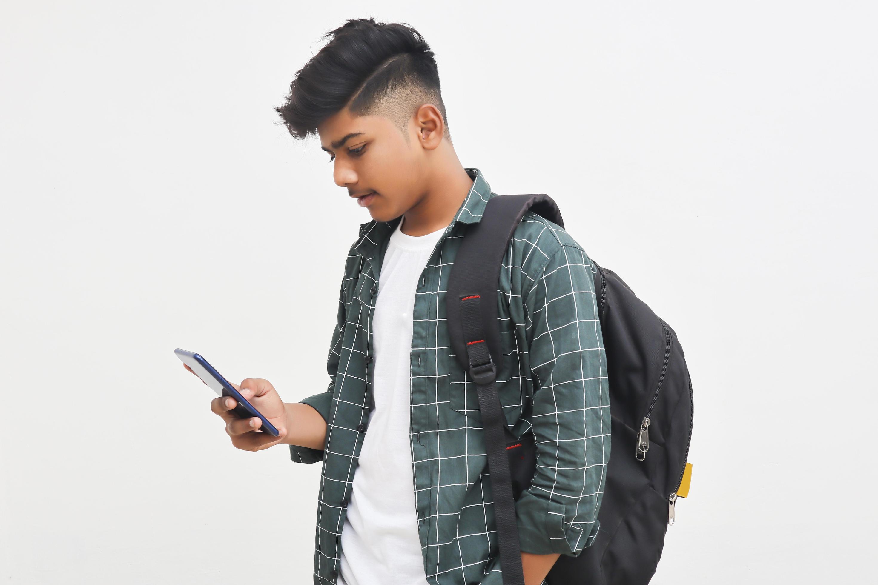 Indian college student using smartphone on white background. 5286179 Stock  Photo at Vecteezy