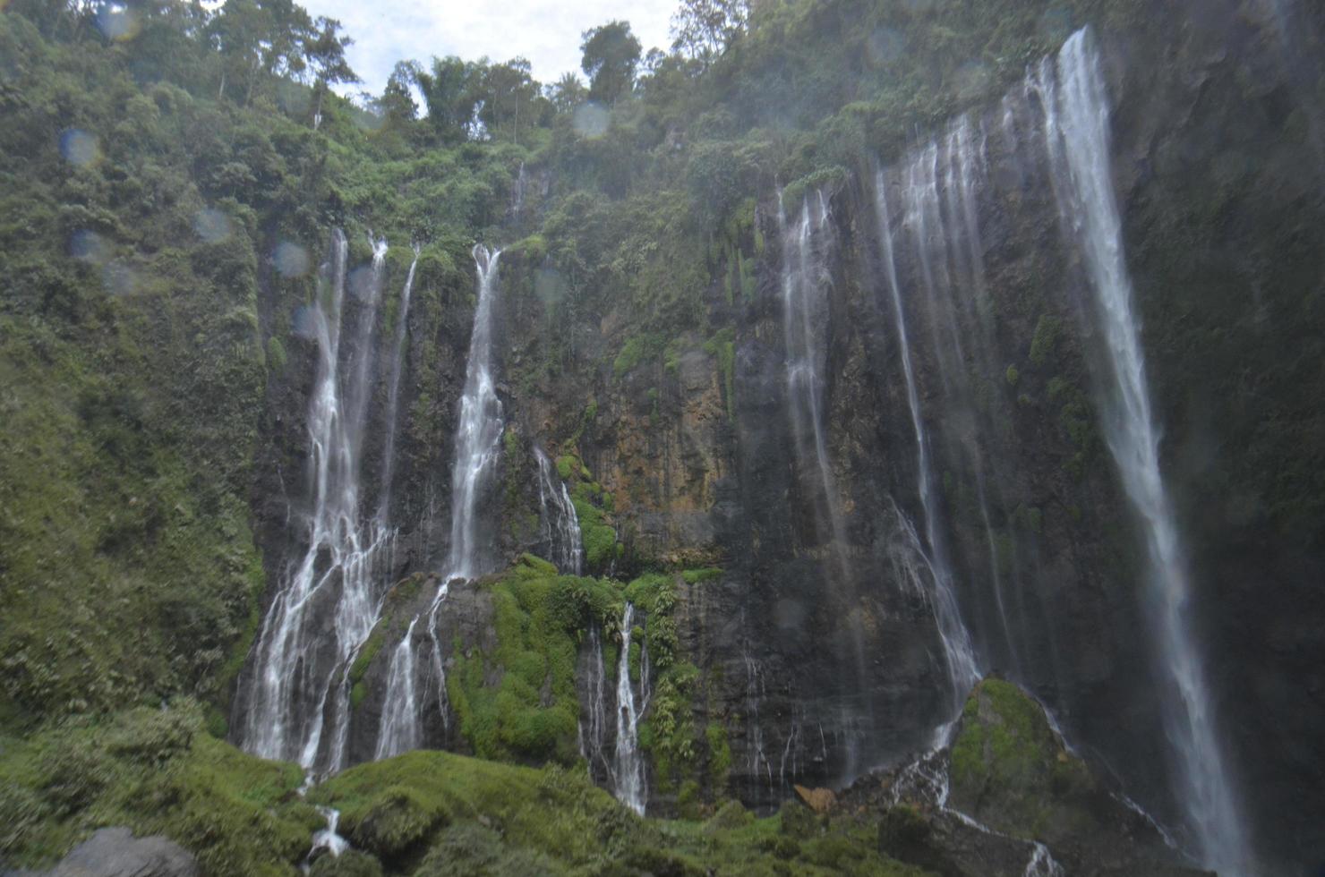 scenery of the waterfall from underneath. summer and waterfall background. Location at Tumpak Sewu Waterfall, Indonesia photo