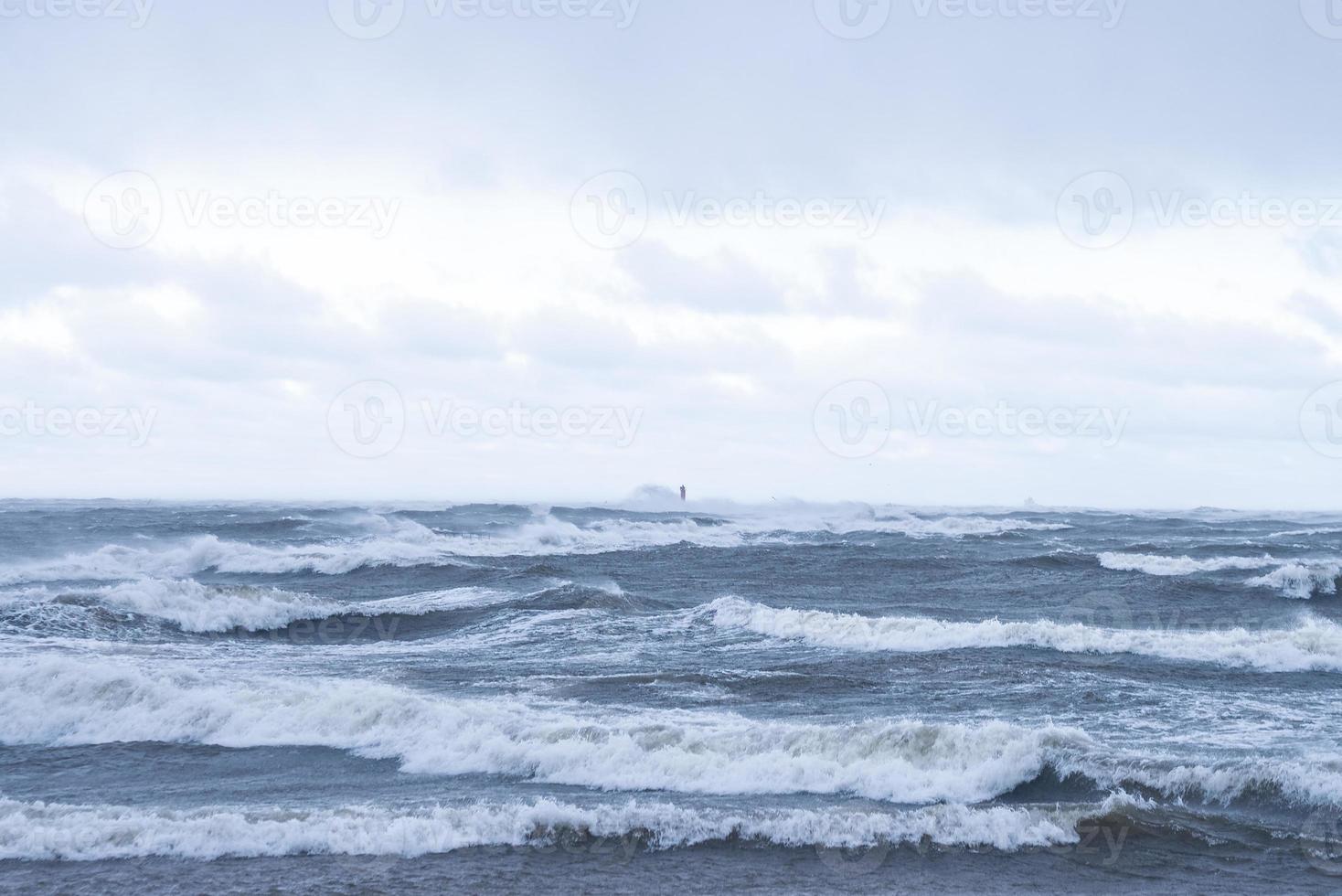 Thunder storm waves crashing on the beach photo