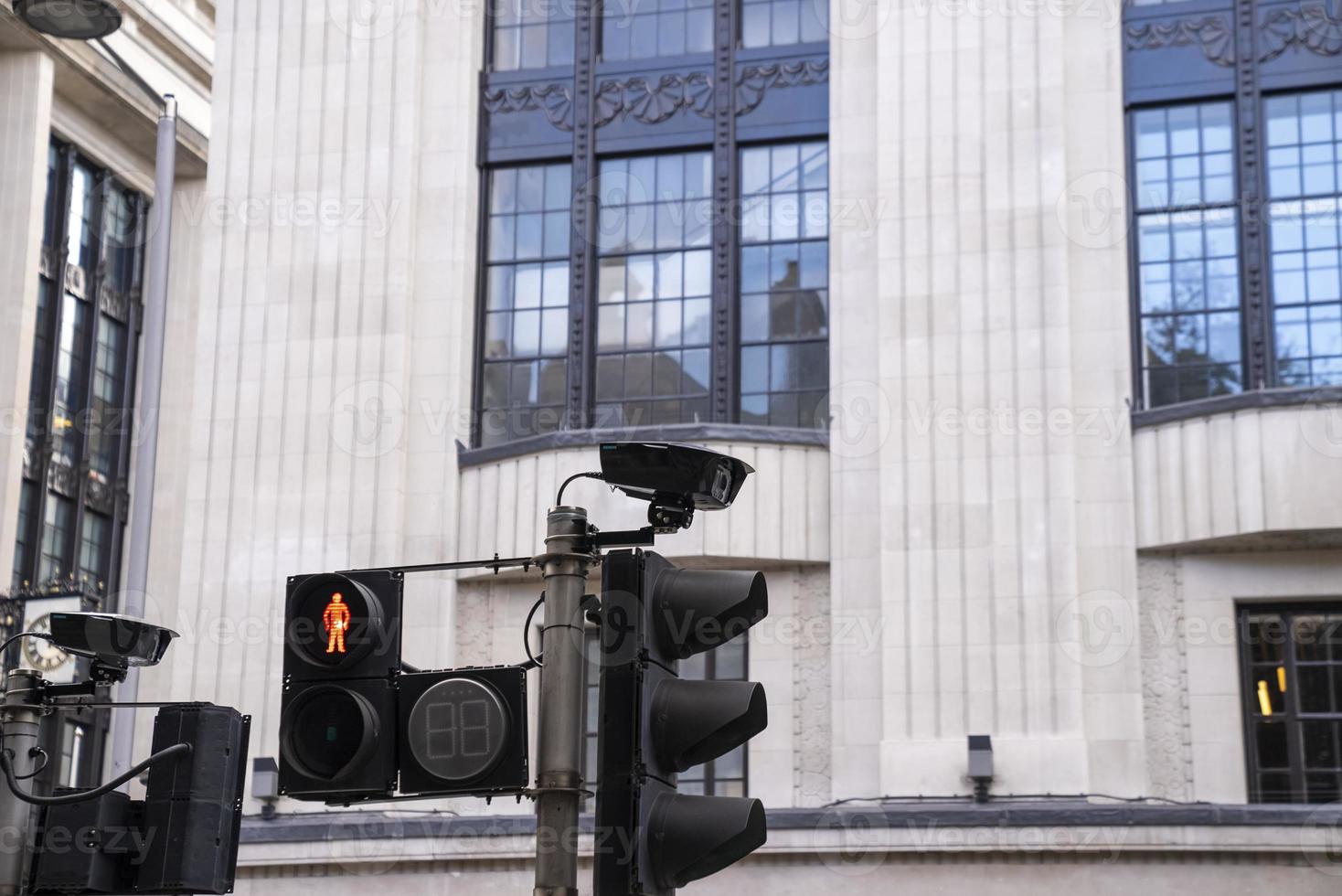 Traffic lights with security cameras on street photo