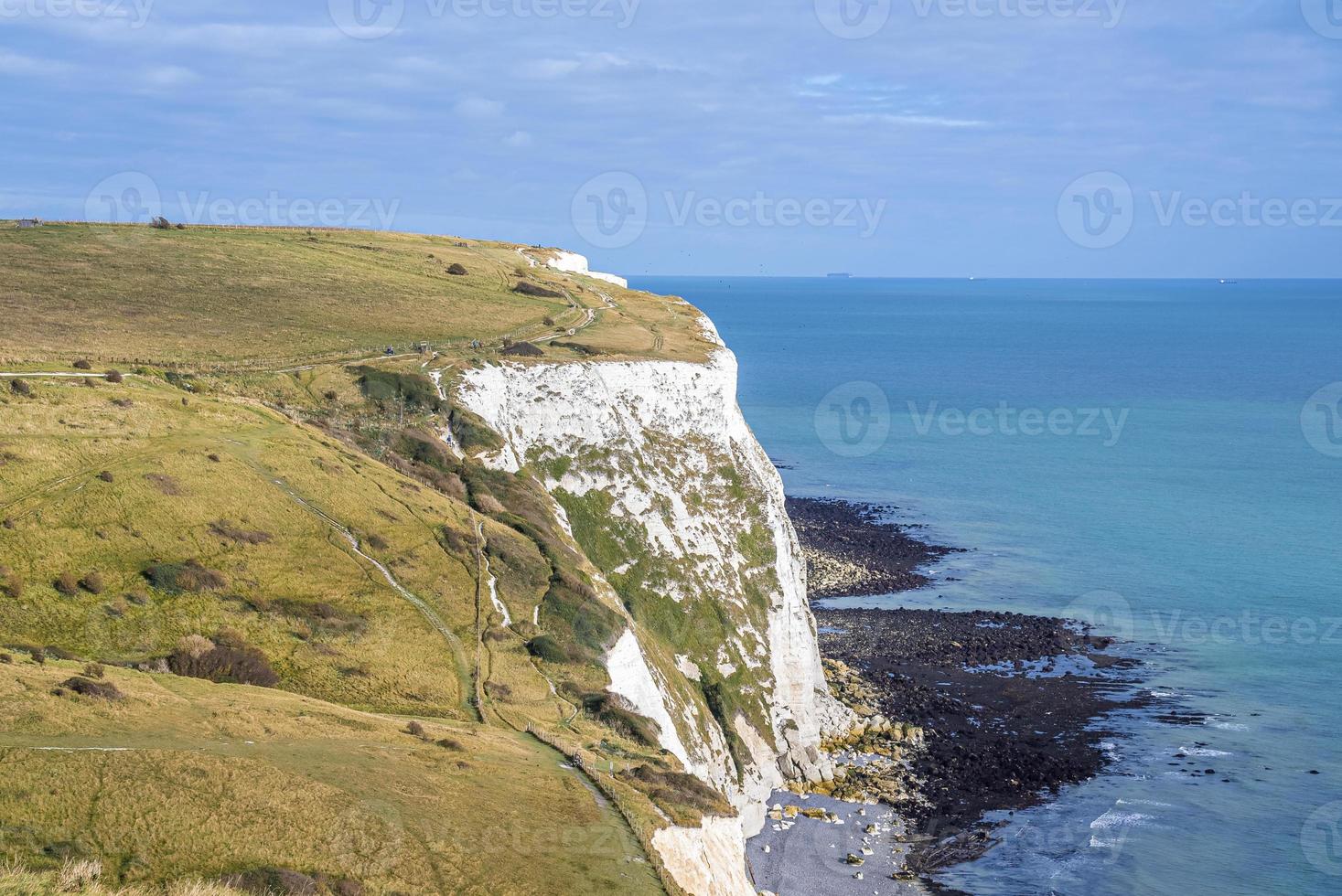 Scenic view of white cliffs with sea on sunny day photo