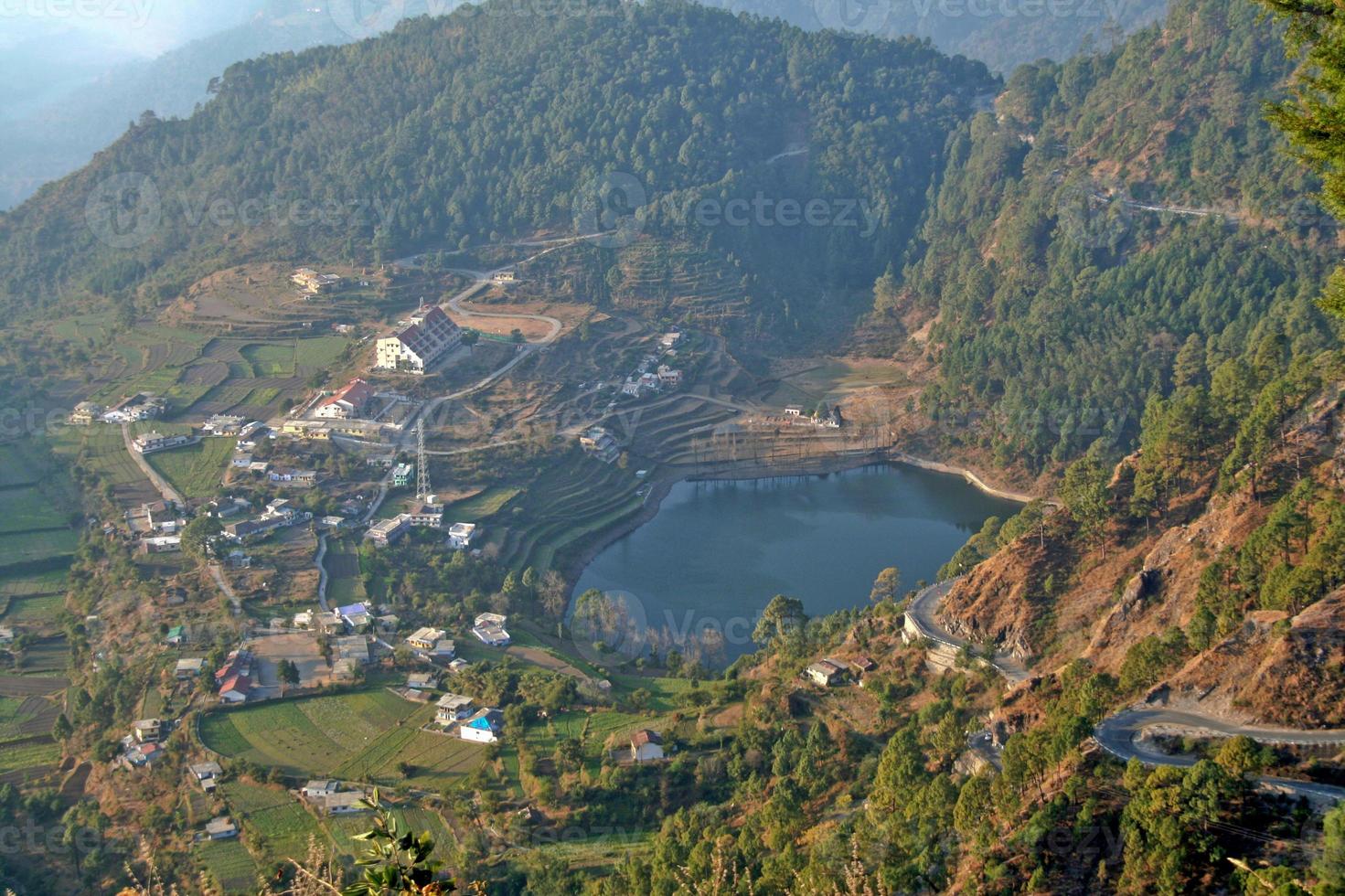 View of lake surrounded by mountains near Nainital photo